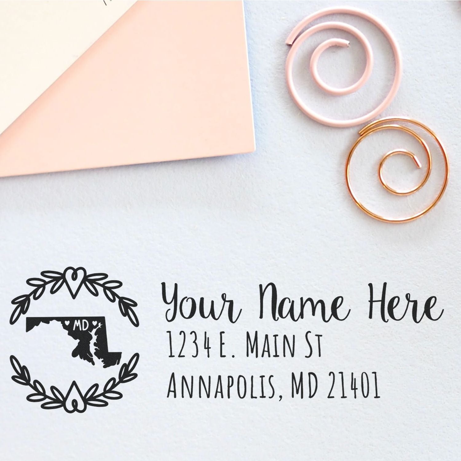 Custom Maryland return address rubber stamp with floral wreath and personalized name, street, and city for envelopes.