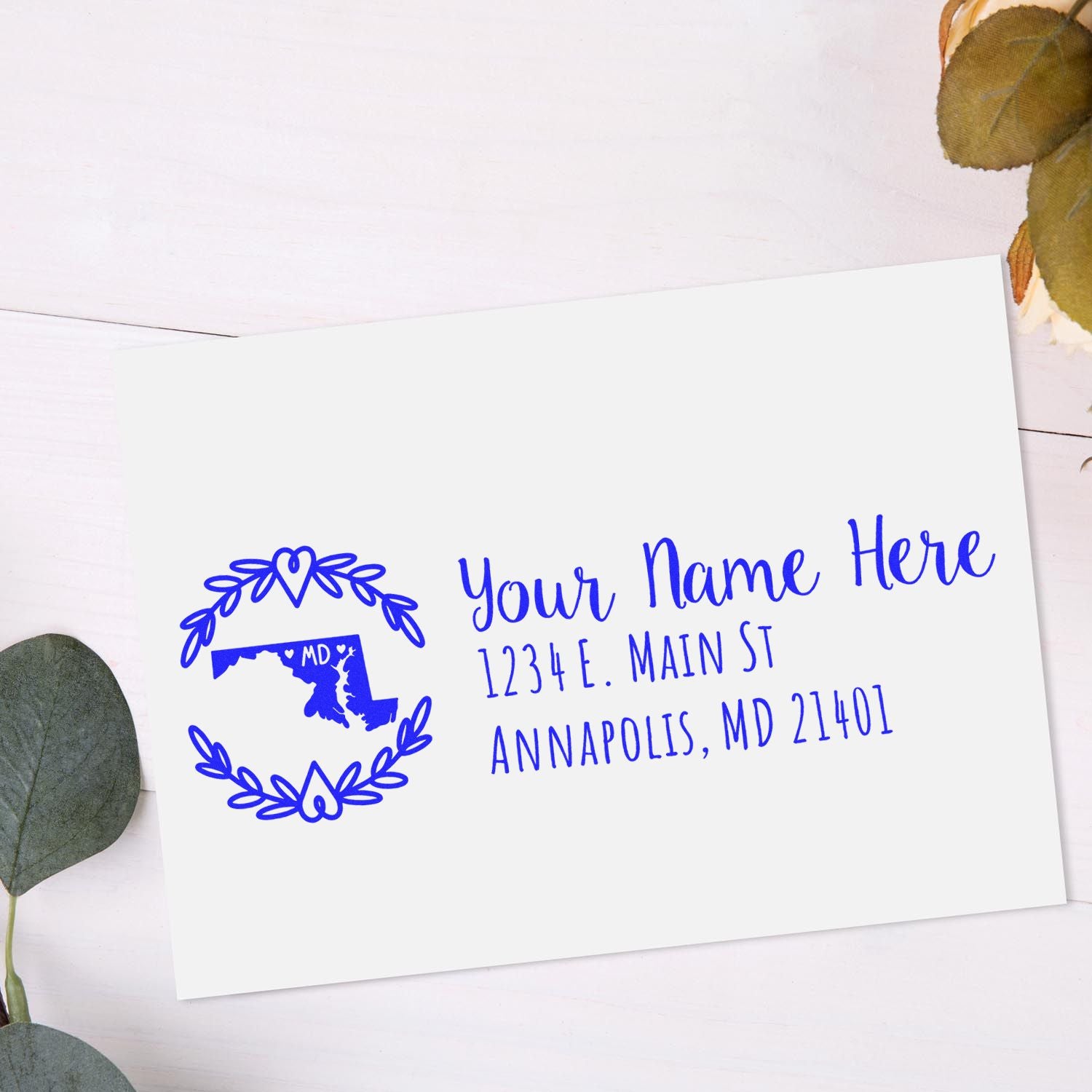 Personalized return address rubber stamp with Maryland state map and floral wreath for custom mailing labels.