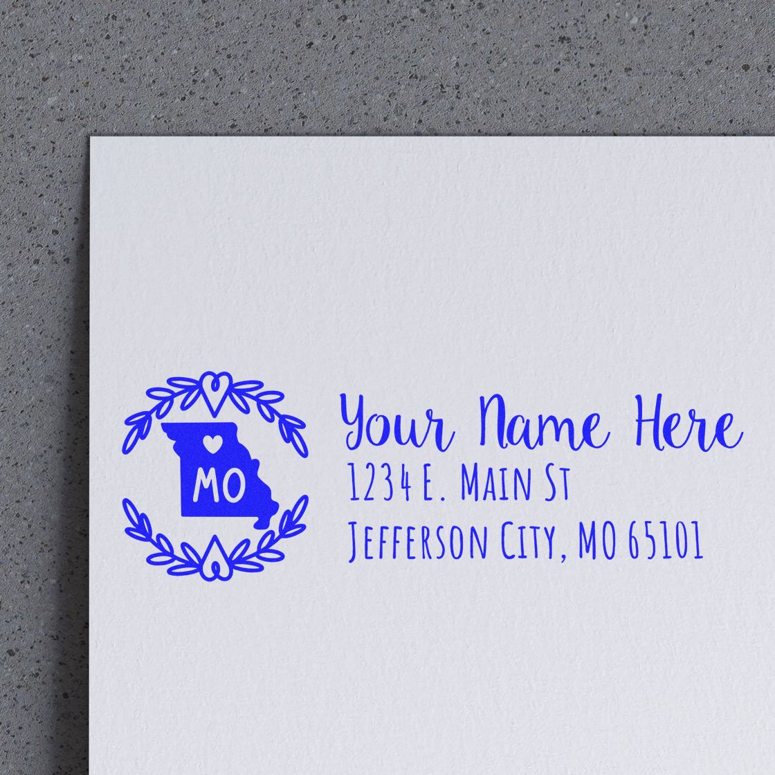 Custom rubber stamp with Missouri state logo, wreath border, and personalized name and return address imprint.