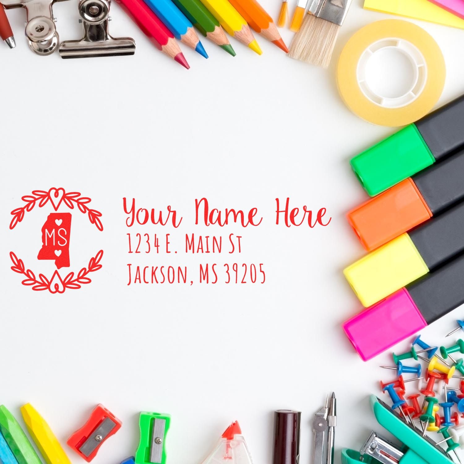 Custom return address rubber stamp with Mississippi state design, personalized name and address, surrounded by colorful school supplies.
