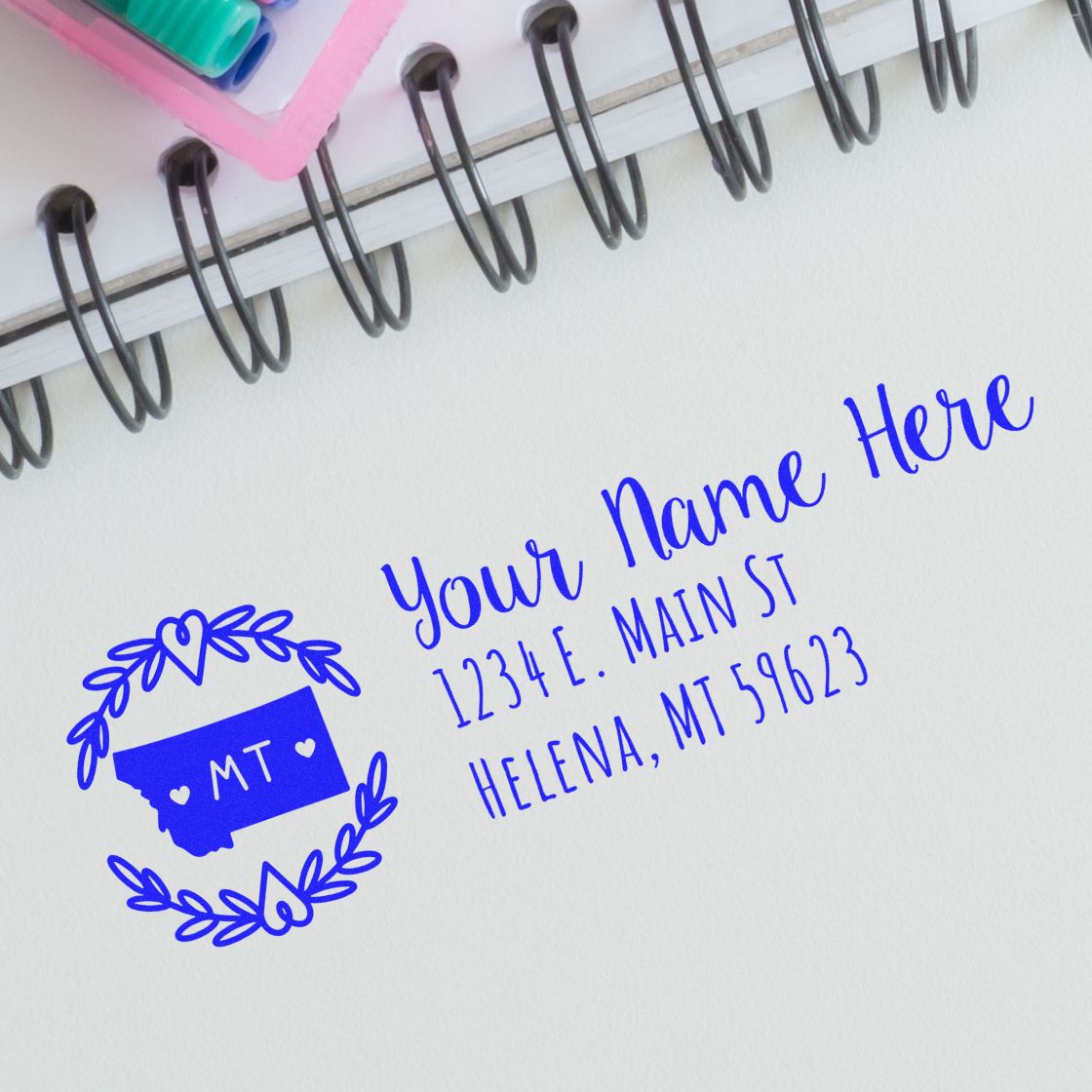 Personalized Montana address rubber stamp design with name, street, city, state, and ZIP code on notebook paper.