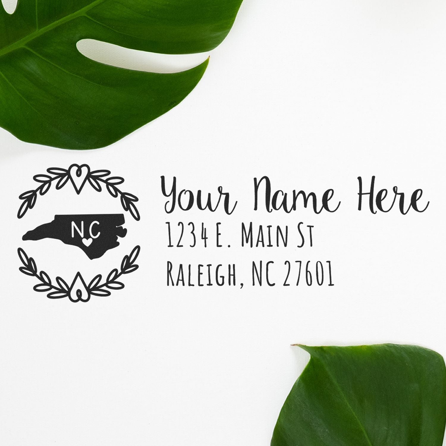 Personalized North Carolina return address rubber stamp with floral wreath, custom name, and Raleigh, NC address for wedding invitations and mail.
