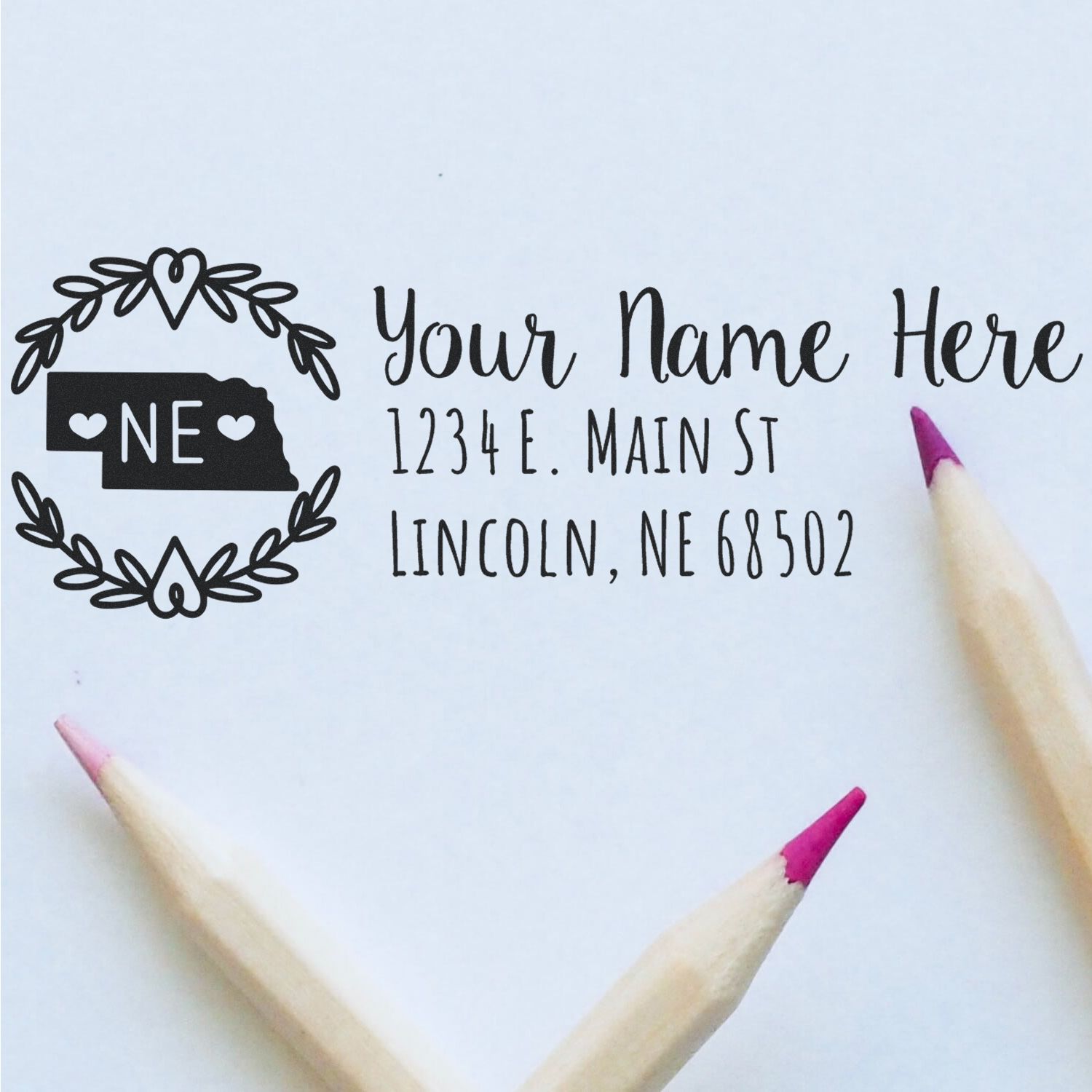 Personalized Nebraska address rubber stamp design with floral wreath, name, street address, and ZIP code.