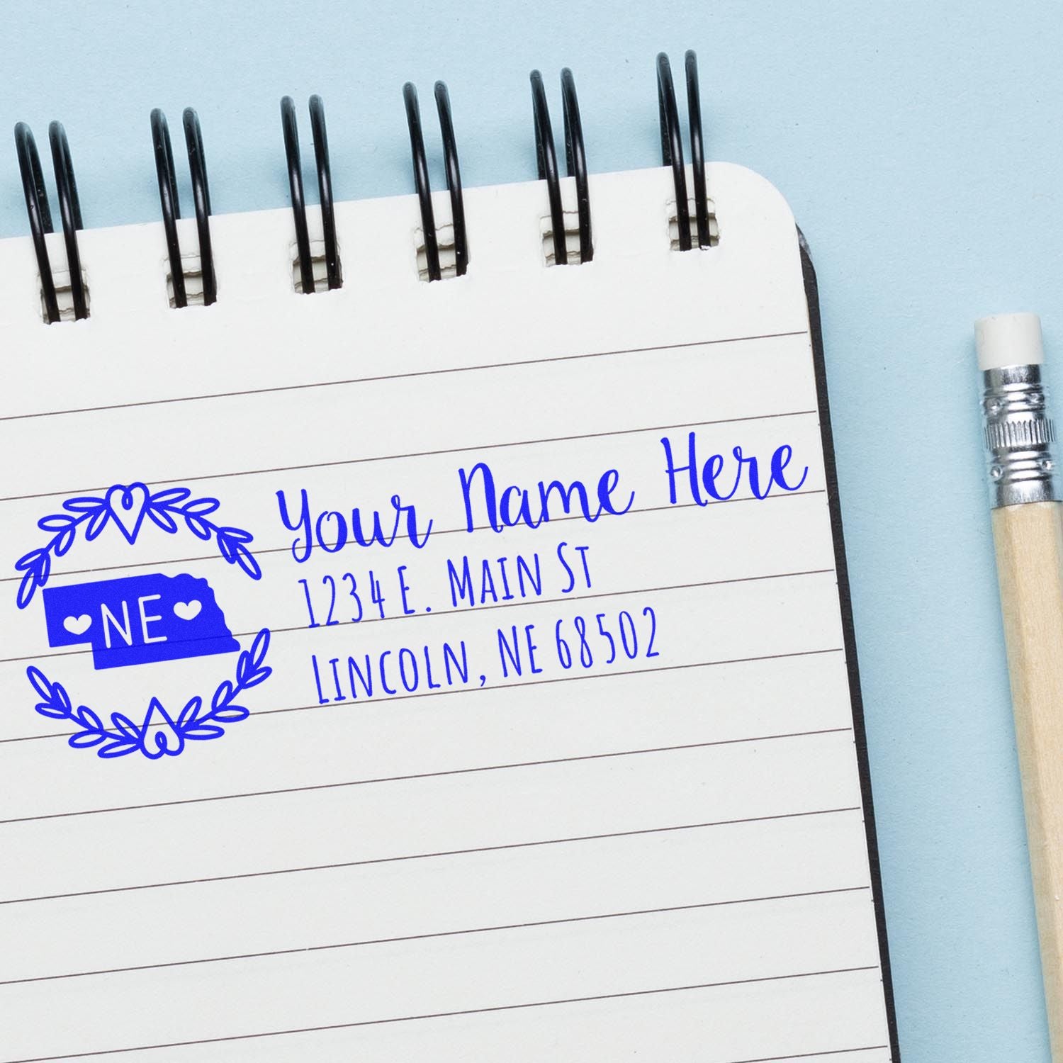 Custom Nebraska address rubber stamp impression with name, street, city, and ZIP on notebook paper.