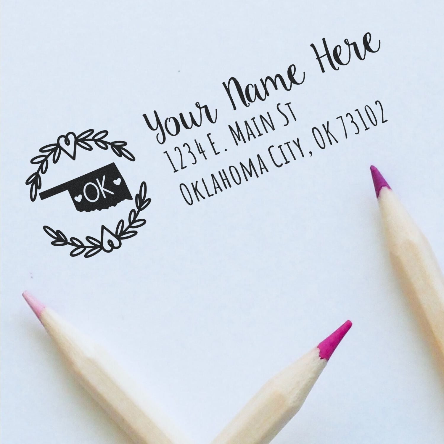 Custom return address rubber stamp sample with name, Oklahoma City, OK address, and decorative OK wreath design.
