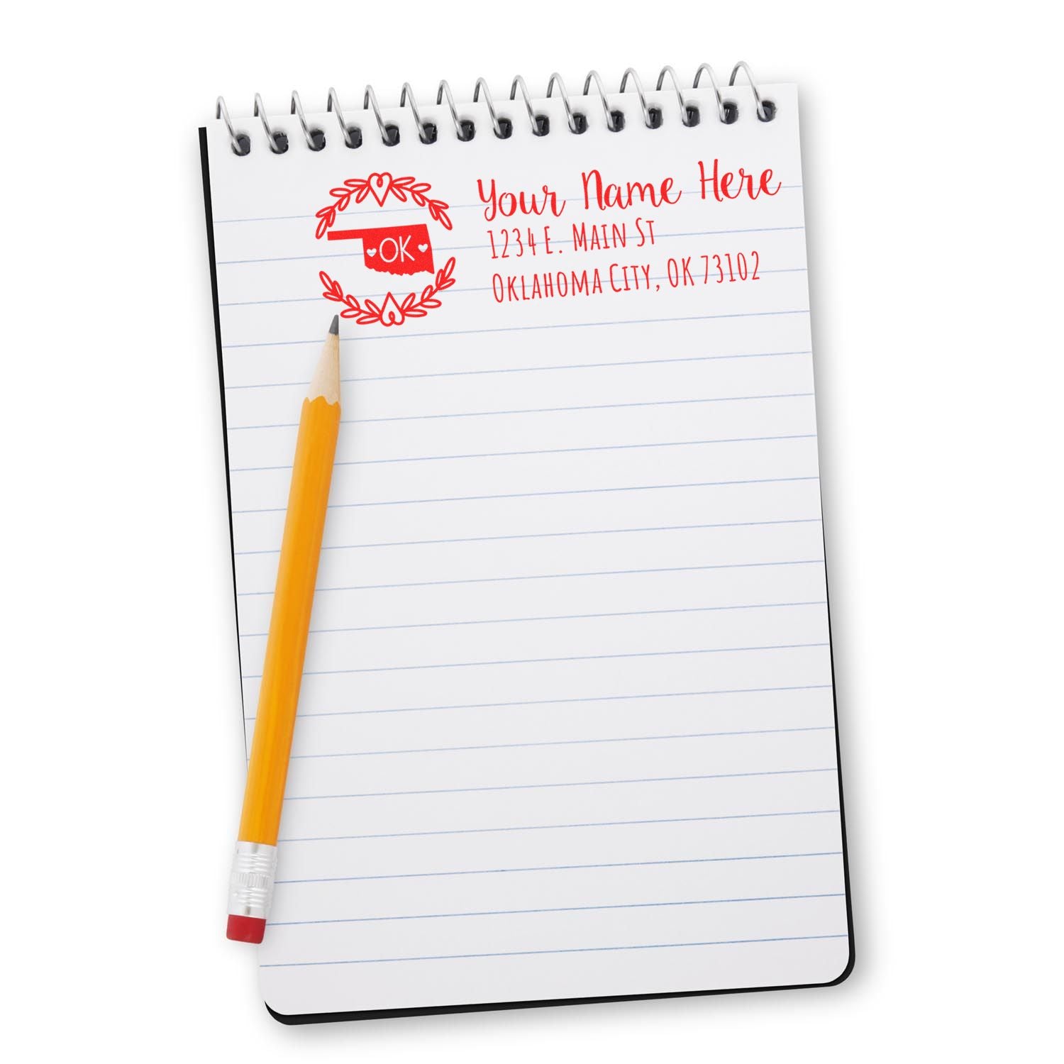 Custom Oklahoma return address rubber stamp with name and mailing address, shown on notebook paper with pencil.