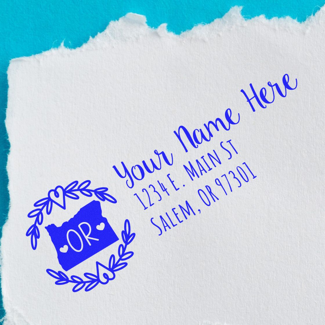 Personalized Oregon return address rubber stamp with name, street, and Salem, OR ZIP code on paper.