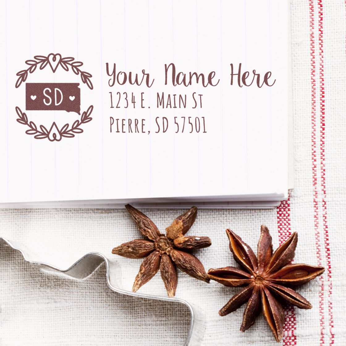 Personalized return address rubber stamp with South Dakota monogram, name, and Pierre, SD mailing address for envelopes.