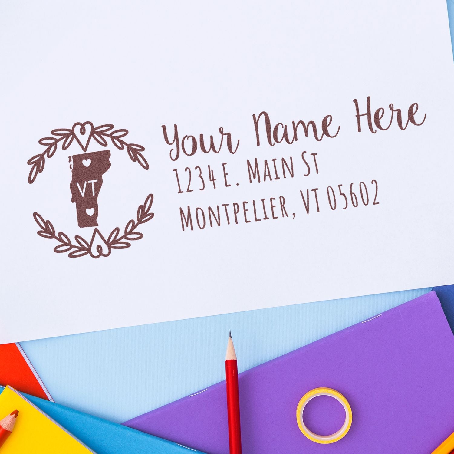 Custom return address rubber stamp with Vermont state design, showing personalized name, street, and city for mailing envelopes.