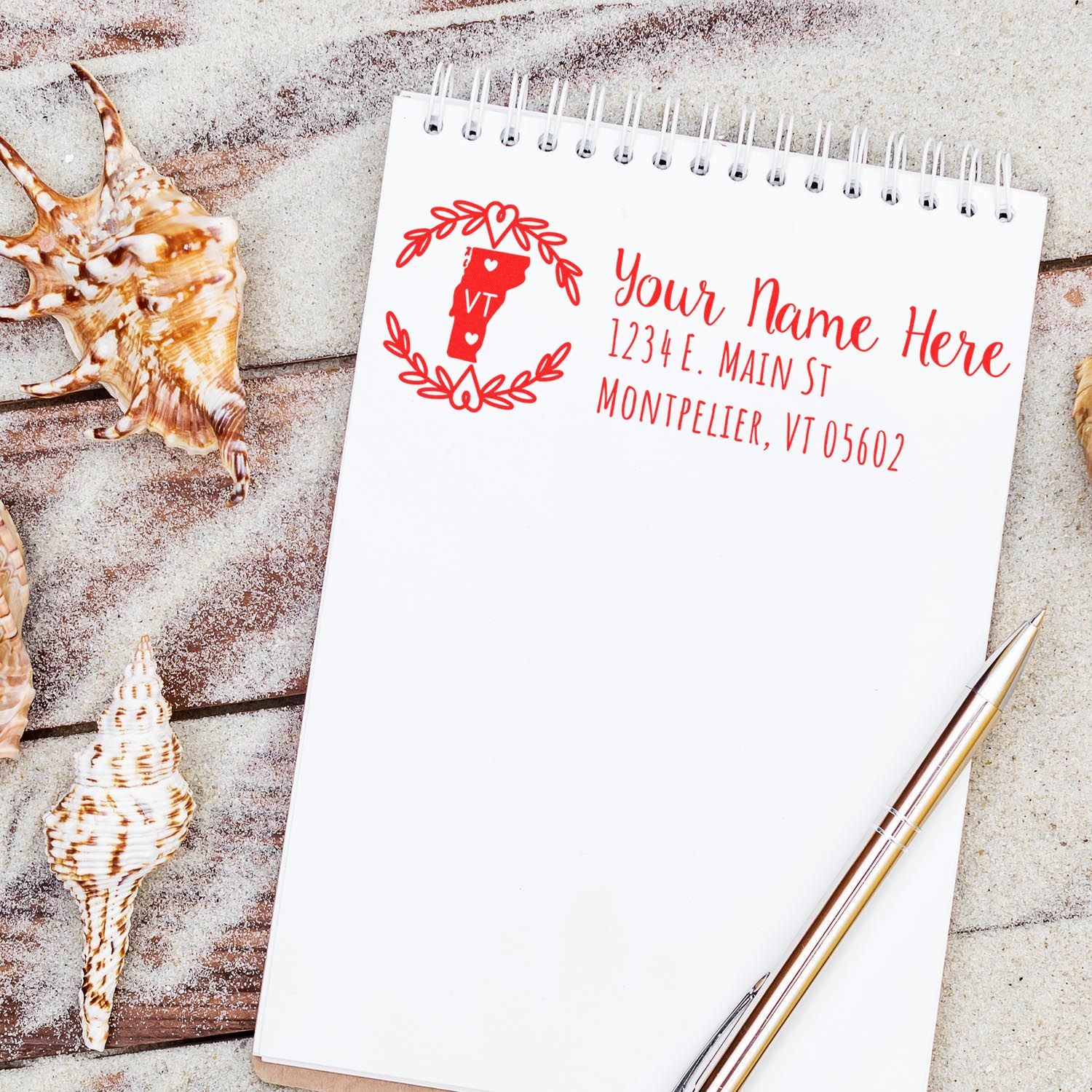 Personalized Vermont return address rubber stamp mockup on notebook, featuring name, address, and state monogram wreath design.