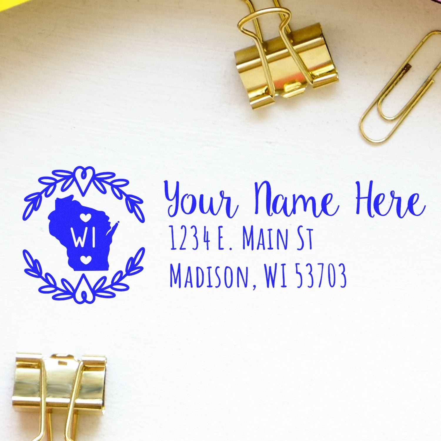 Custom rubber stamp with Wisconsin state design and return address, featuring personalized name and Madison, WI address in blue ink.