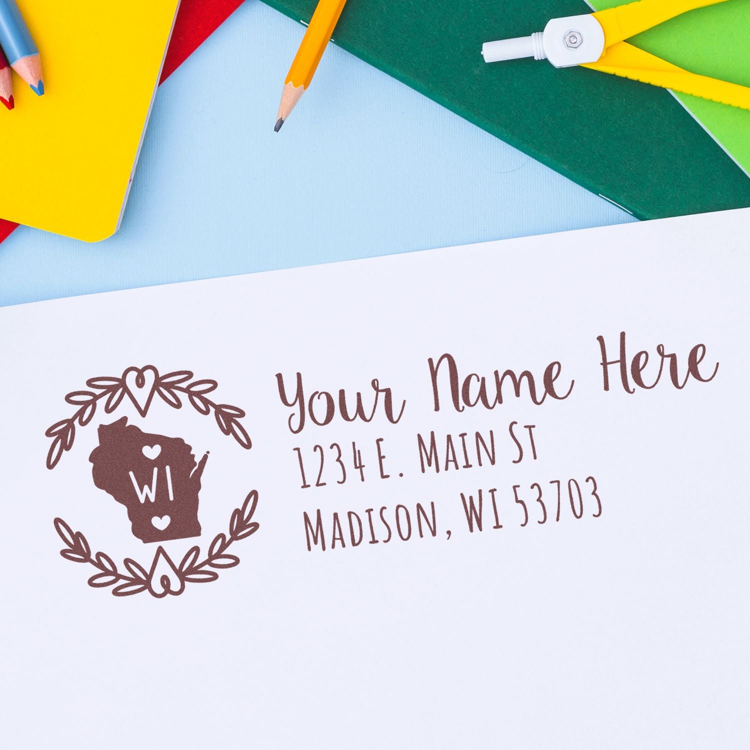 Custom Wisconsin address rubber stamp with name and return address for personalized mailing envelopes.