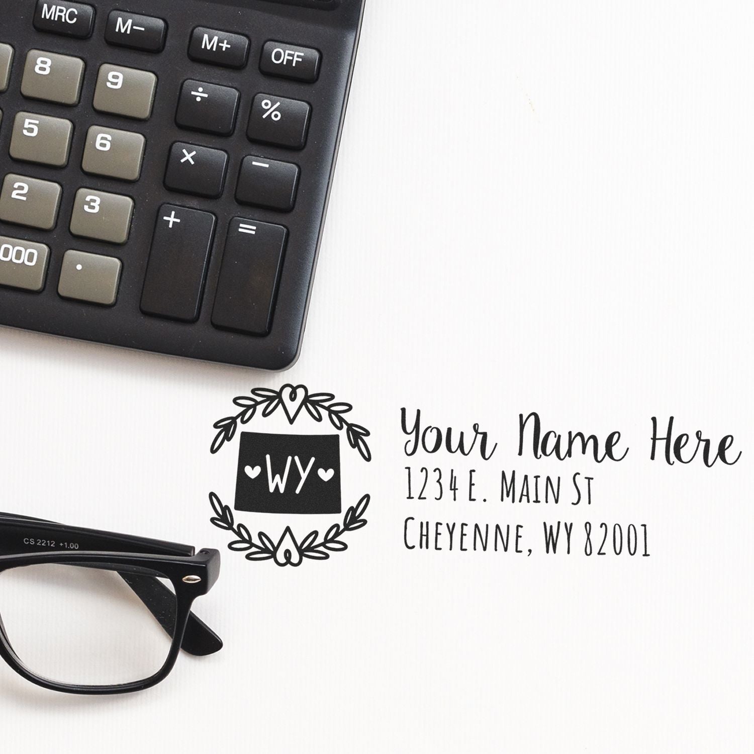 Custom return address rubber stamp for personalized mail, featuring Wyoming monogram and address imprint.