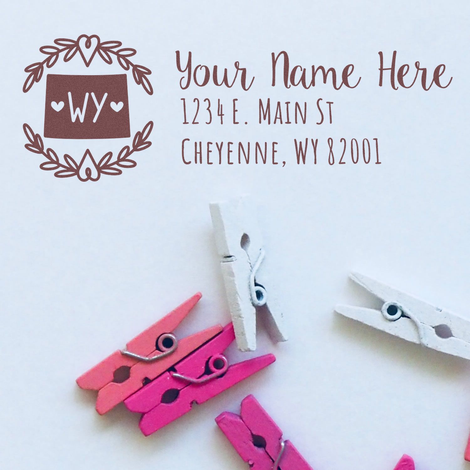 Personalized return address rubber stamp with laurel wreath and Wyoming state design, showing custom name and address template.