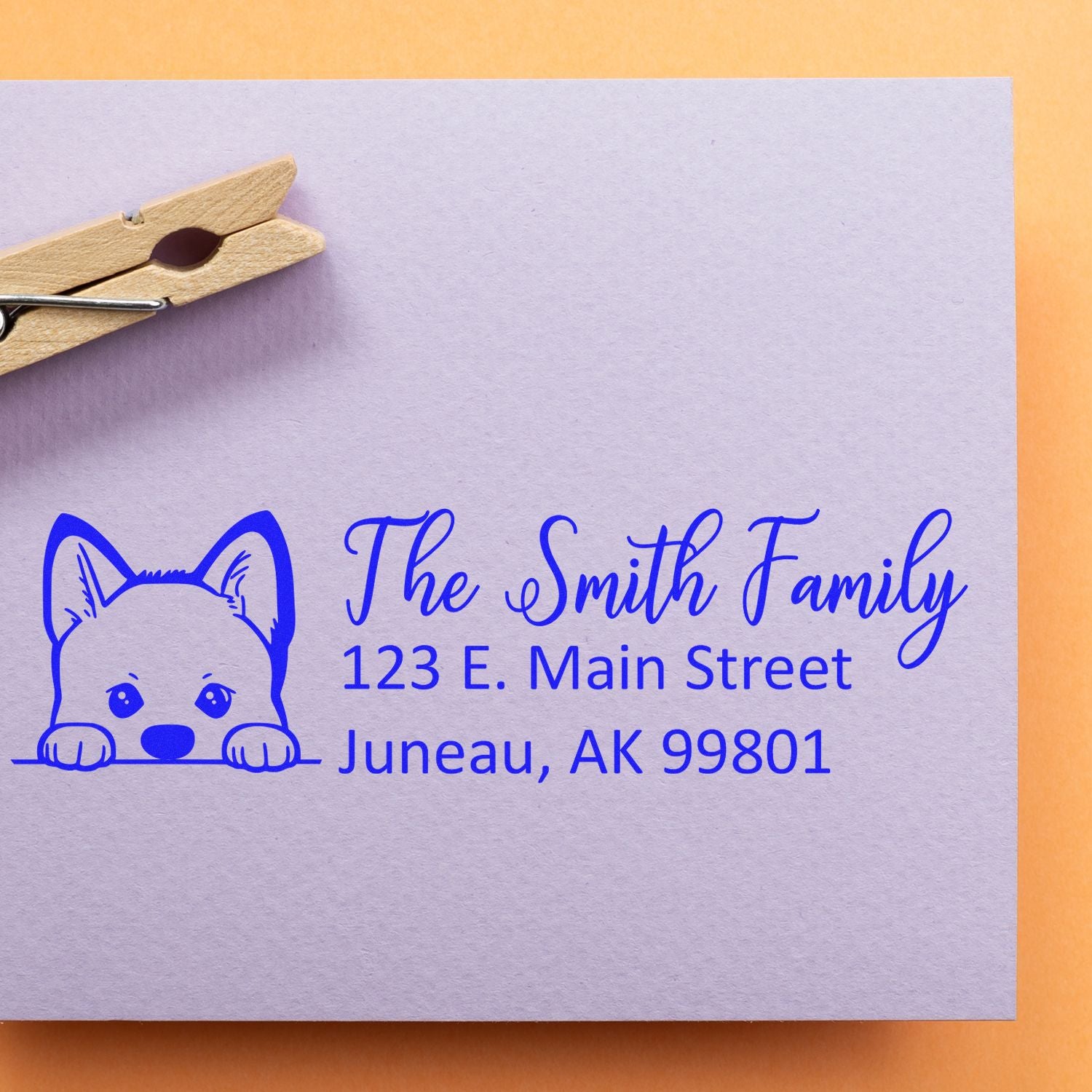 Custom dog-themed address rubber stamp with family name, street address, and city for personalized mailing labels.
