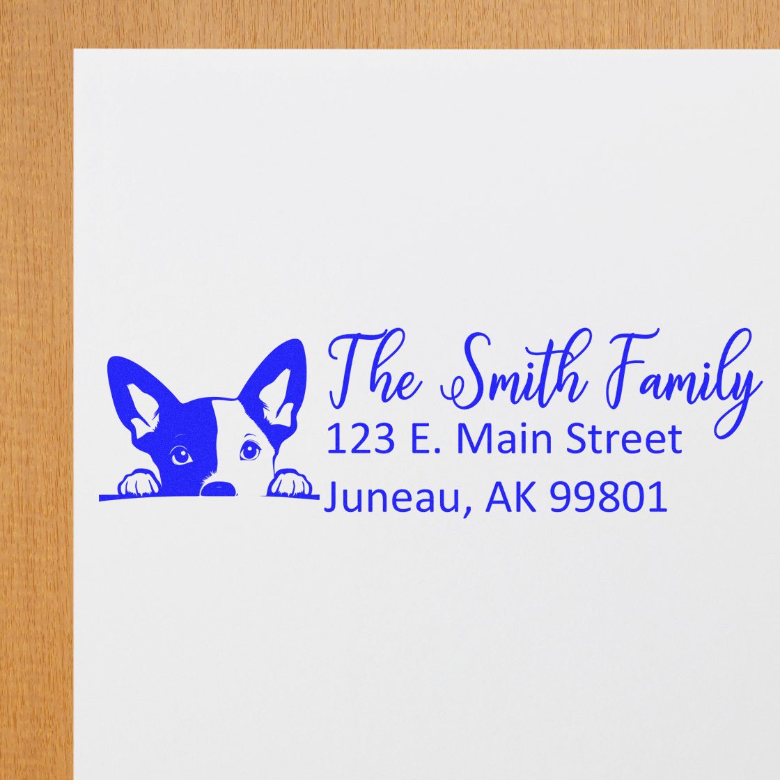 Custom rubber stamp with dog logo and The Smith Family address, 123 E. Main Street, Juneau, AK 99801 in blue ink.