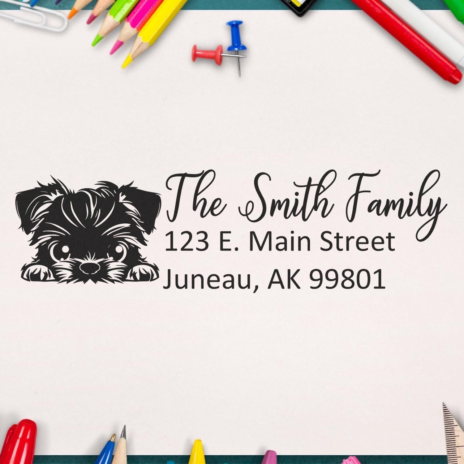 Custom return address rubber stamp with dog portrait for The Smith Family, Juneau AK, on stationery background.