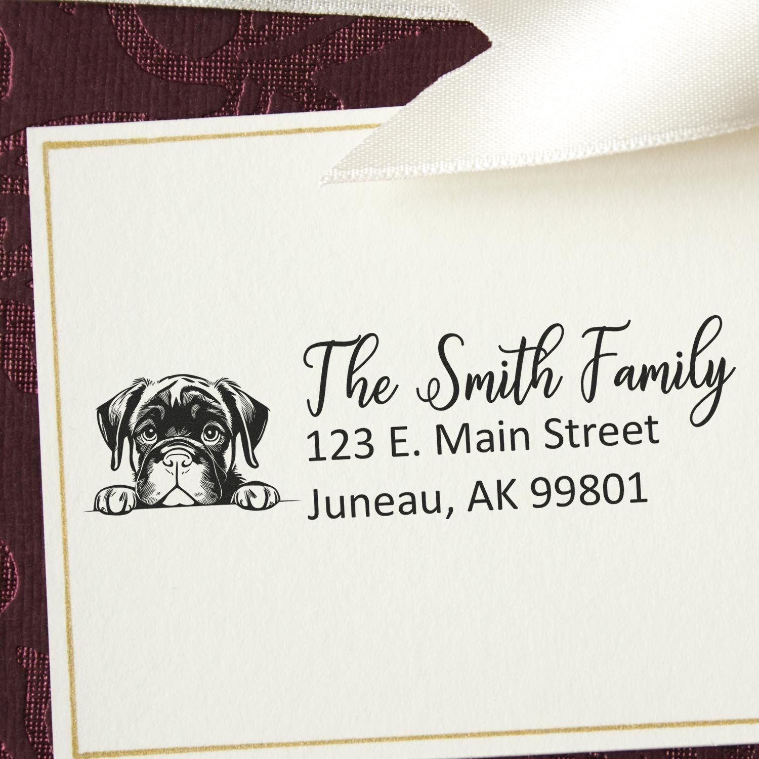 Custom family return address rubber stamp with boxer dog design and Juneau, AK address for personalized stationery.