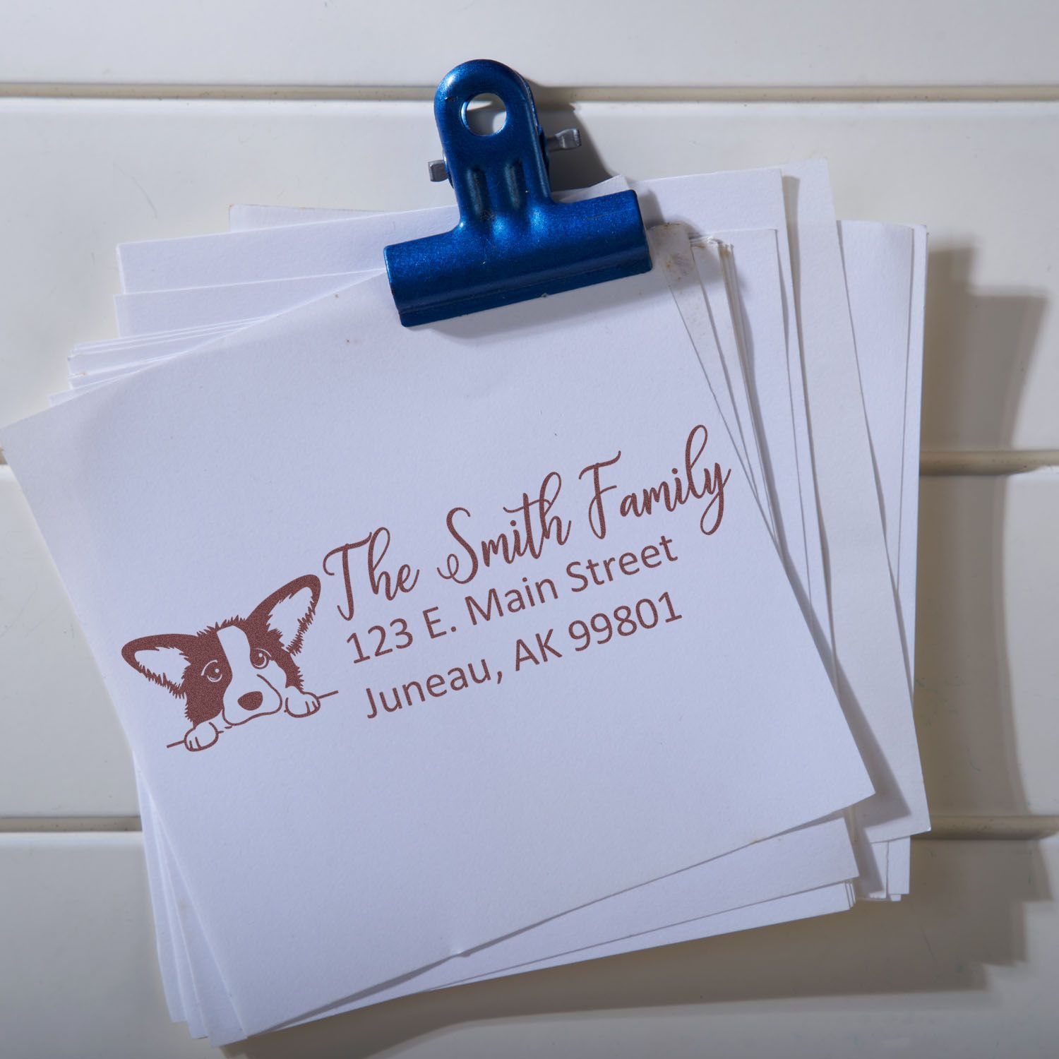 Custom address rubber stamp impression on stacked cards, featuring dog logo and The Smith Family return address.