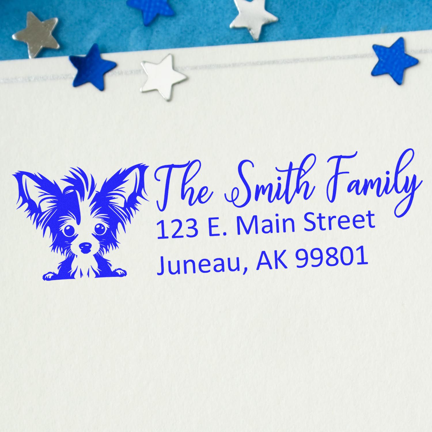 Custom rubber address stamp with dog illustration for The Smith Family, Juneau, AK 99801.
