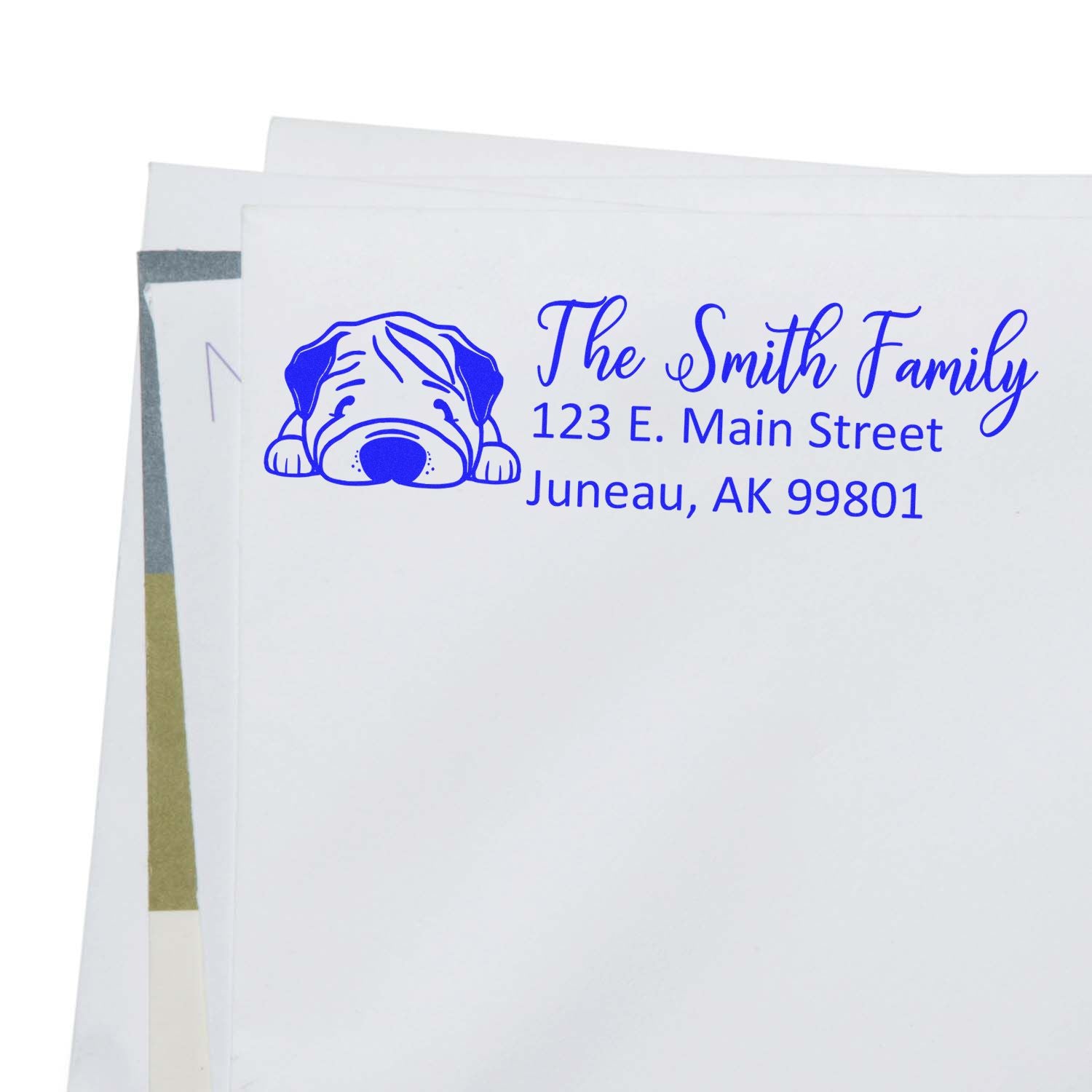 Custom rubber address stamp with dog design and The Smith Family return address on an envelope.