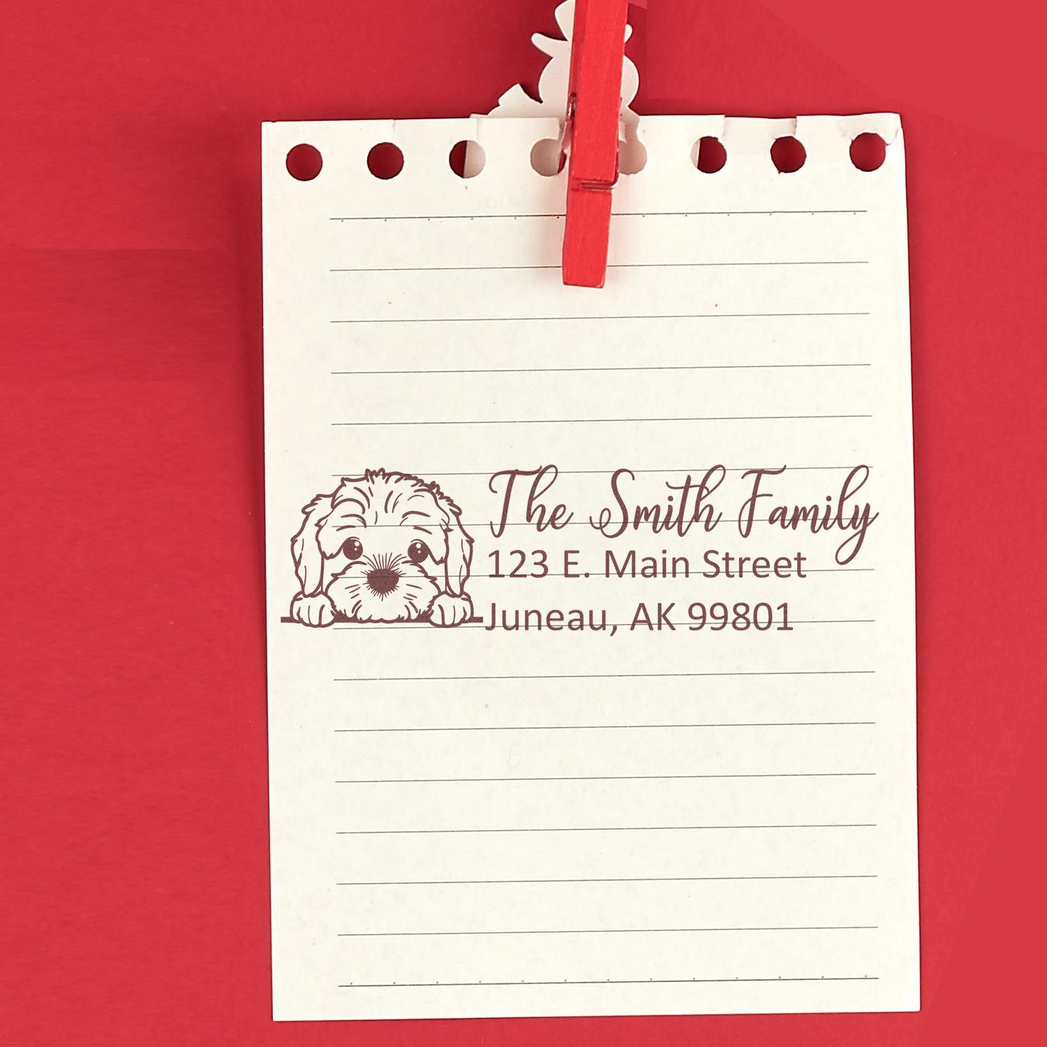 Custom address rubber stamp with dog design on lined note paper, featuring The Smith Family return address in Juneau, Alaska.