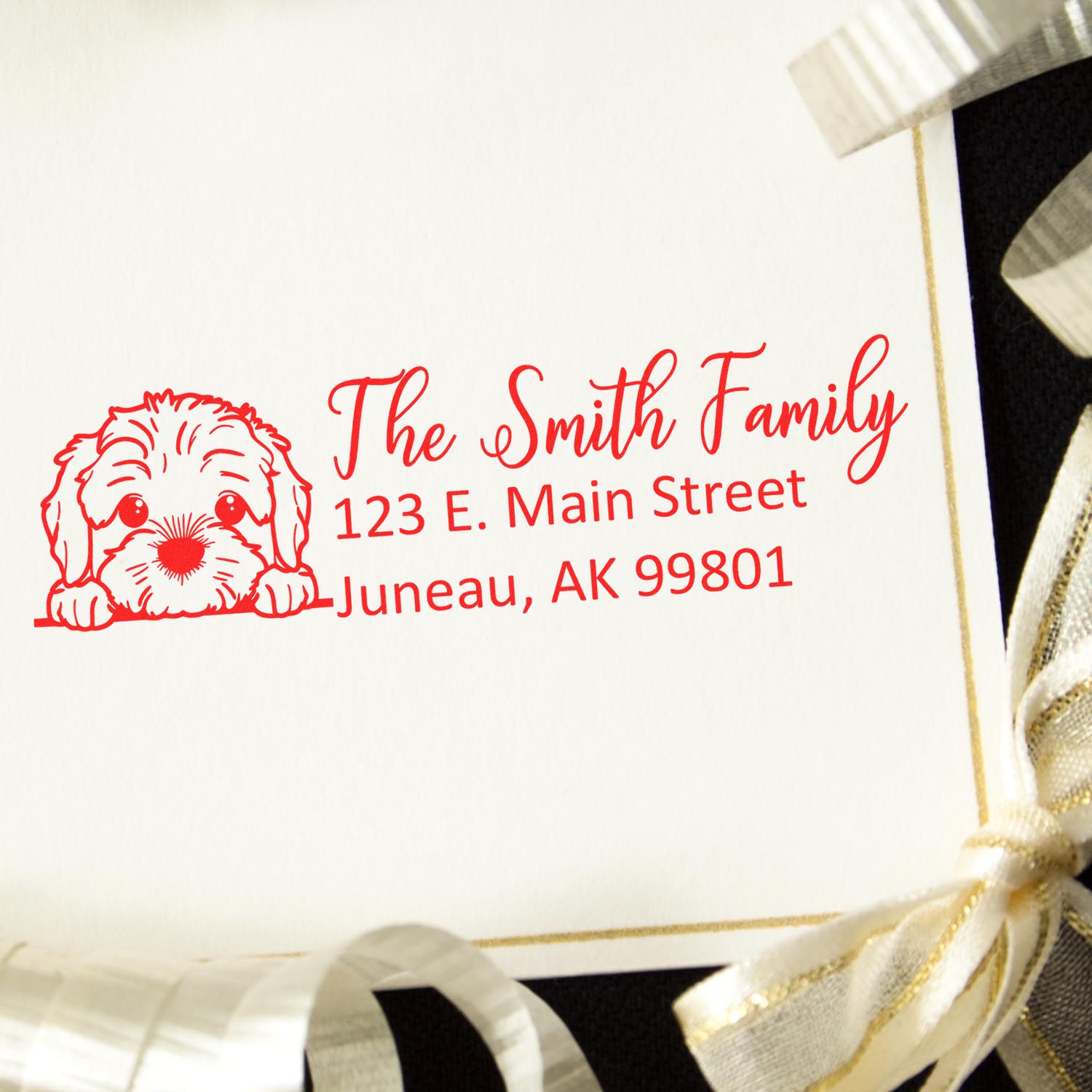 Personalized rubber return address stamp with dog illustration for The Smith Family, Juneau, AK 99801.