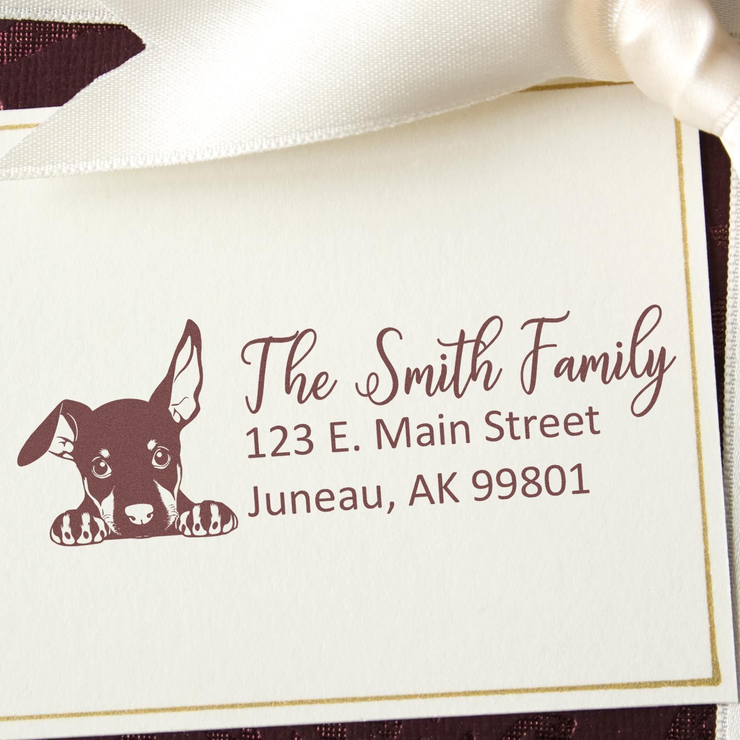 Custom return address rubber stamp with puppy design for The Smith Family, Juneau, AK 99801.