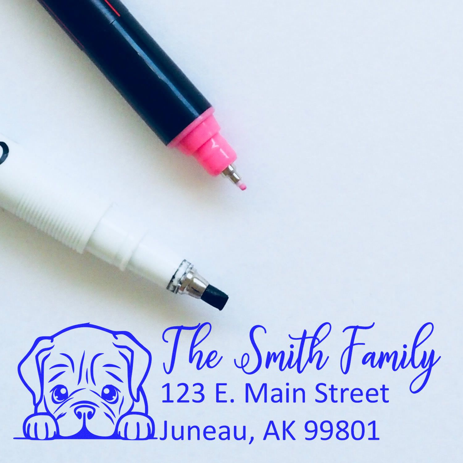 Custom rubber address stamp with dog design for The Smith Family, Juneau AK, ideal for personalized return addressing.