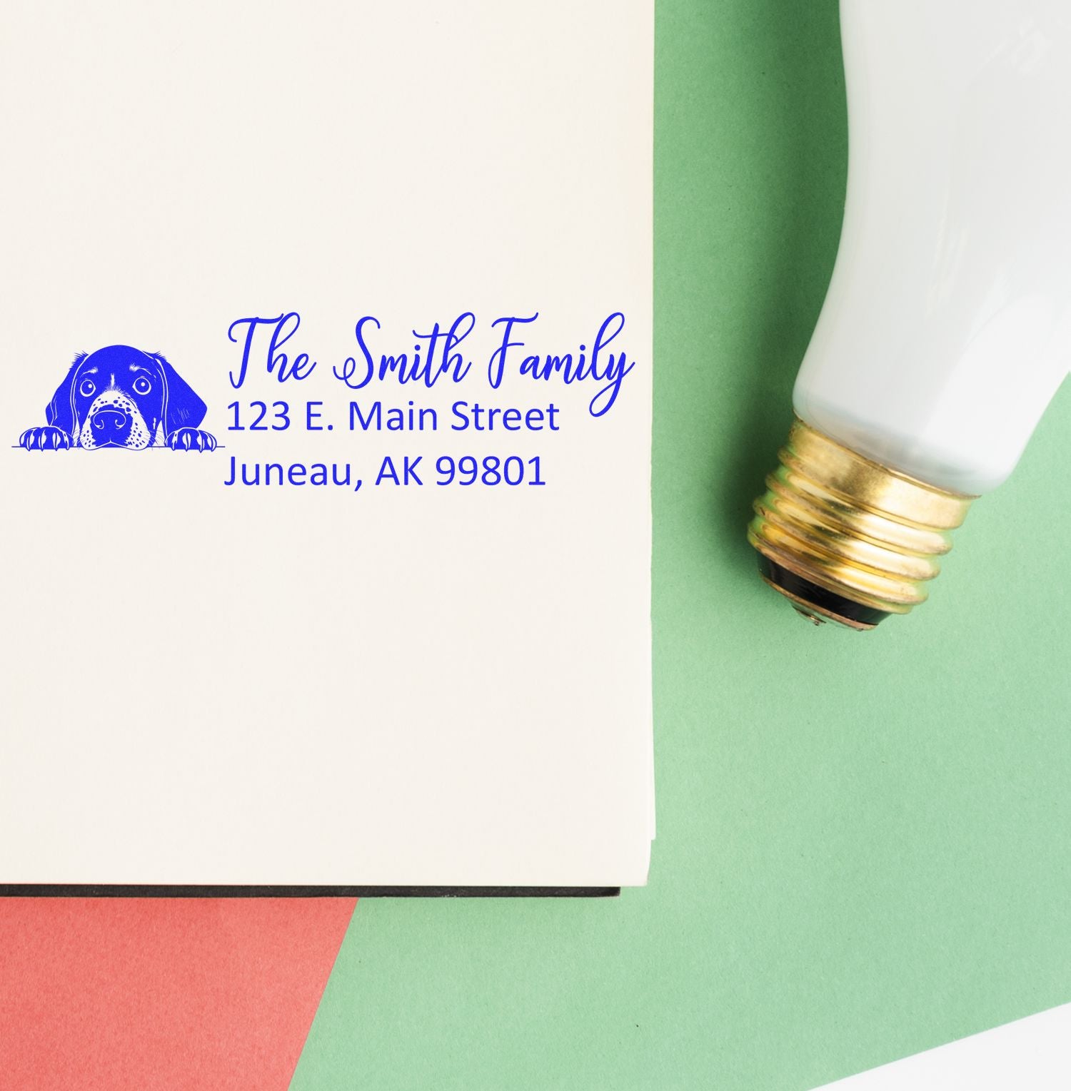 Custom rubber return address stamp for family mailings, featuring dog logo and personalized address.