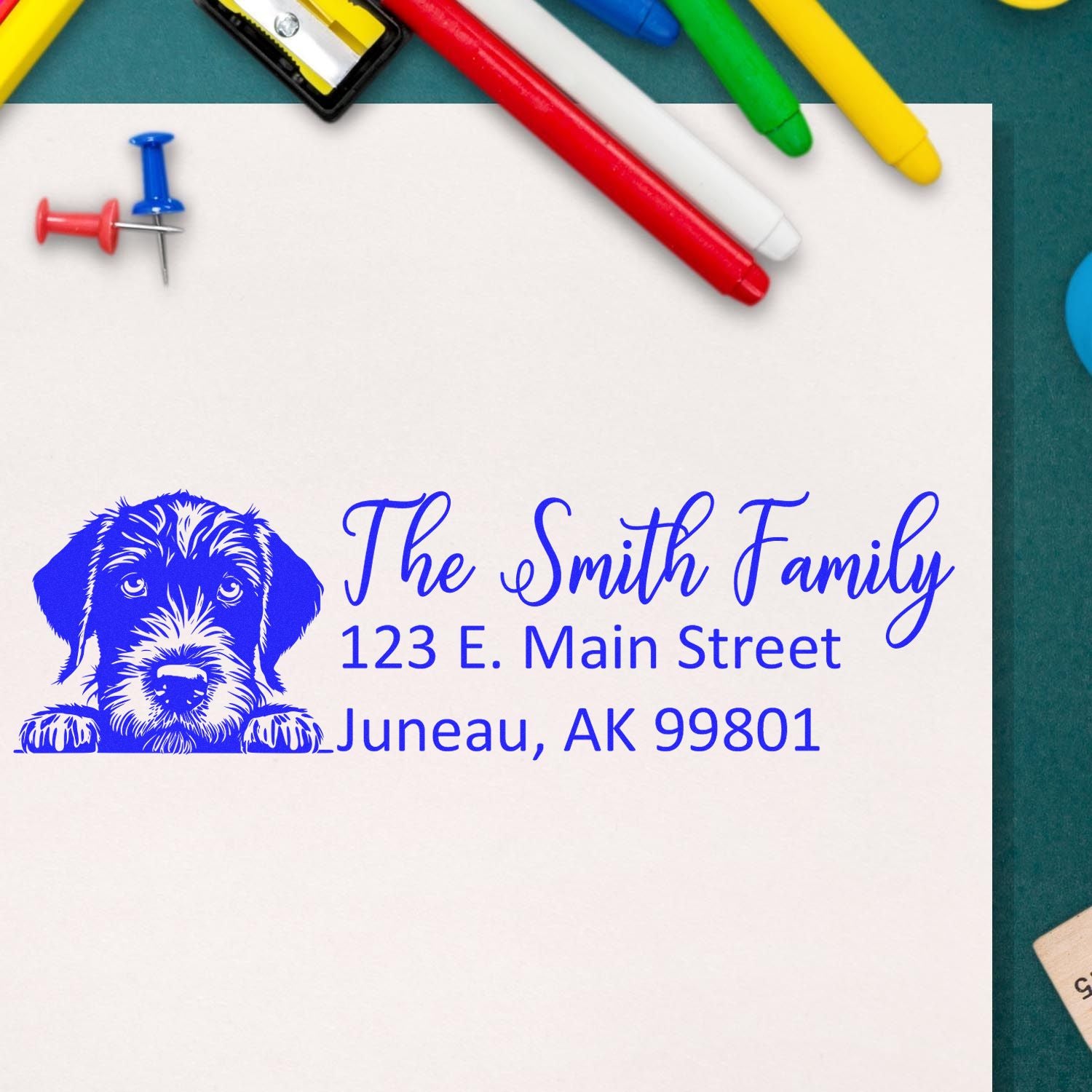 Custom return address rubber stamp with dog illustration for The Smith Family, 123 E. Main Street, Juneau, AK 99801.