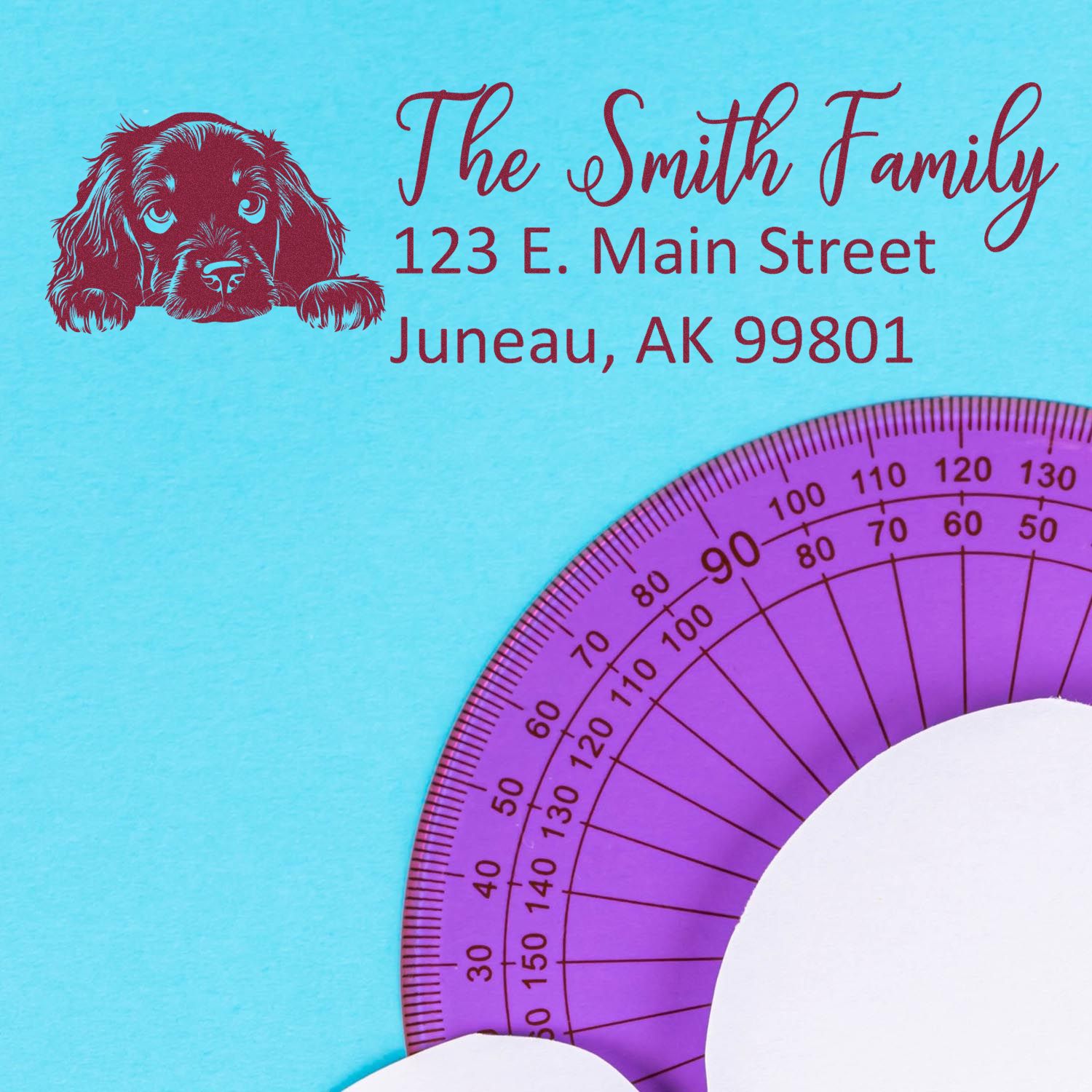Custom return address rubber stamp with dog design, name, and Juneau, AK address