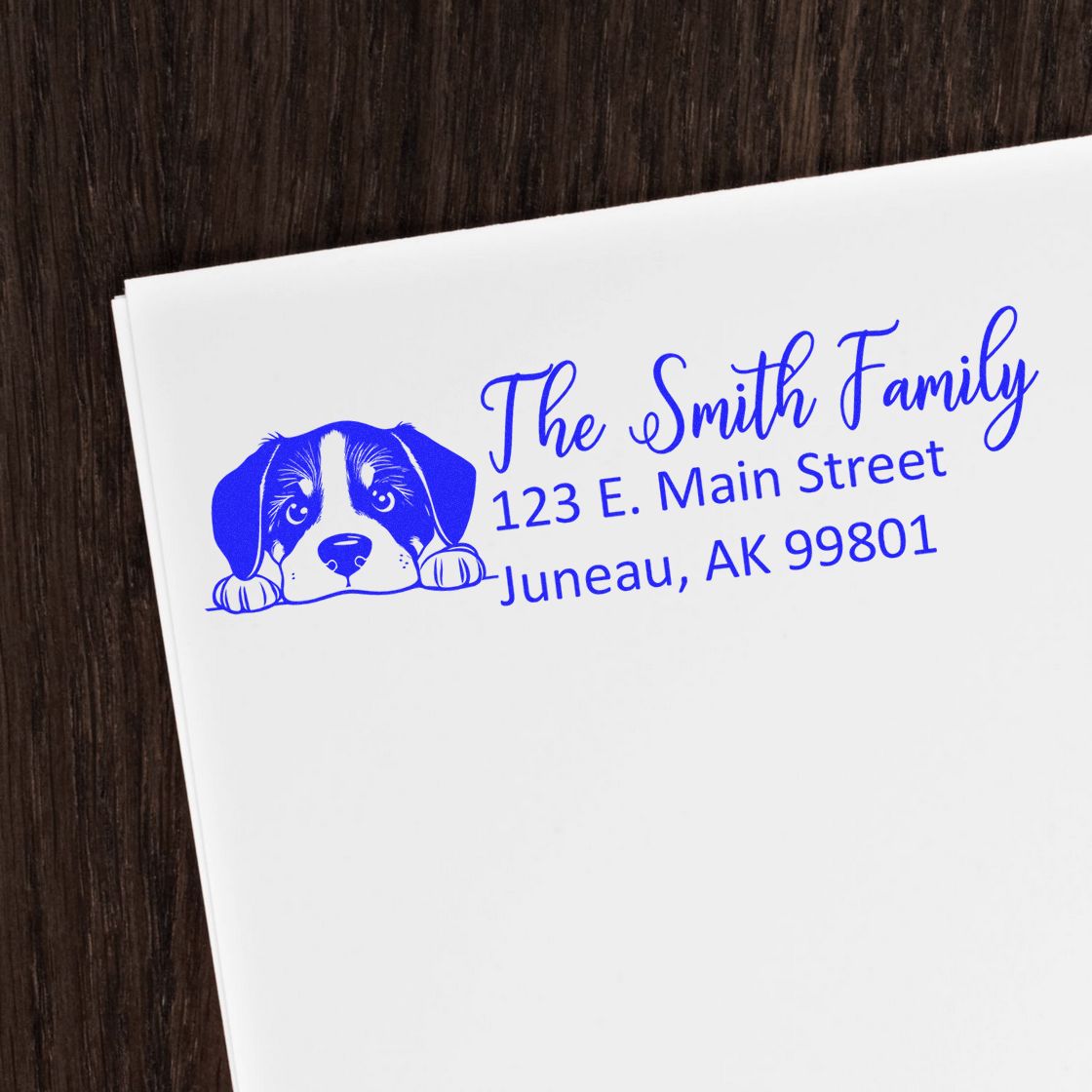Personalized dog address rubber stamp for envelopes with family name and mailing address in blue ink.