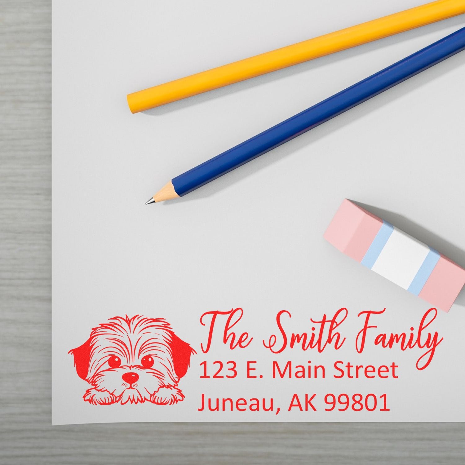 Custom rubber return address stamp with dog illustration, The Smith Family name, and Juneau, AK address for personalized mailings.