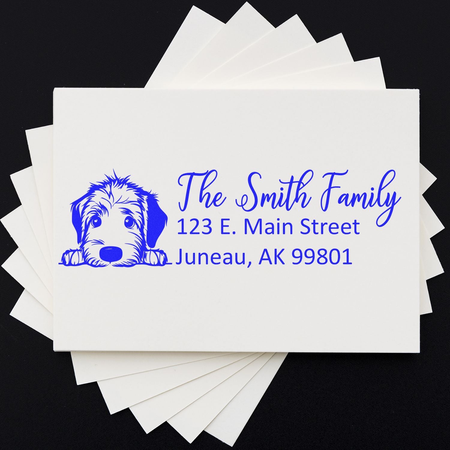 Custom return address rubber stamp with dog illustration for The Smith Family, featuring Juneau, AK mailing address on envelopes.