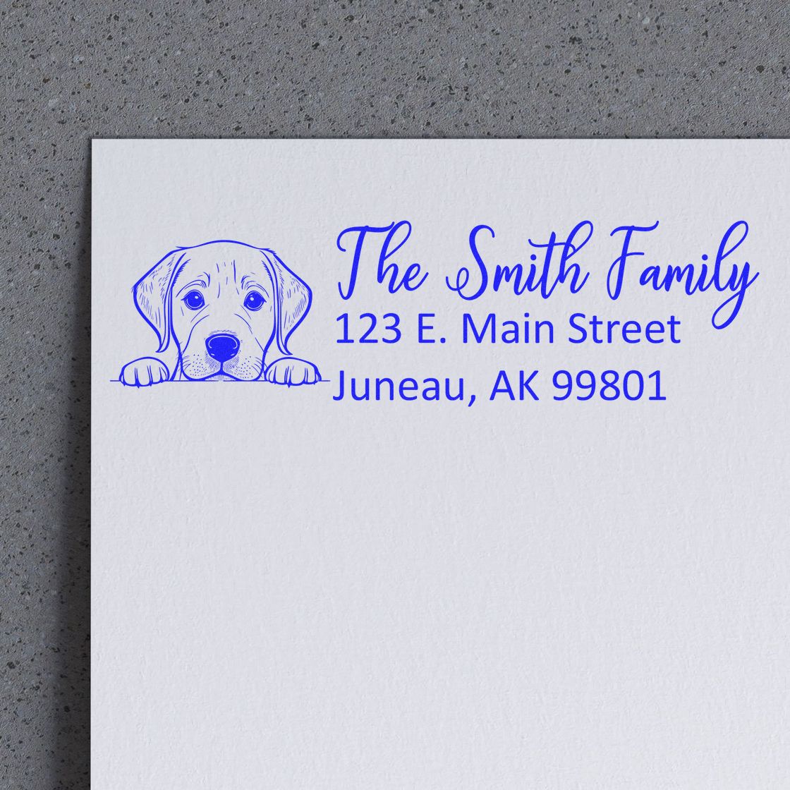 Custom address rubber stamp with dog illustration for The Smith Family, 123 E. Main Street, Juneau, AK 99801.