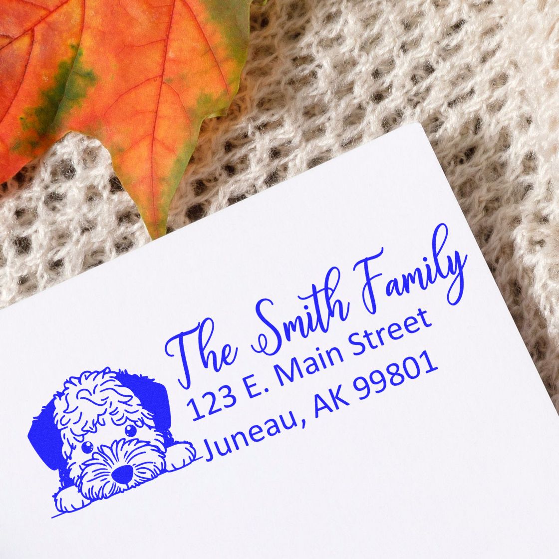 Custom rubber address stamp with dog illustration for The Smith Family, 123 E. Main Street, Juneau, AK 99801.