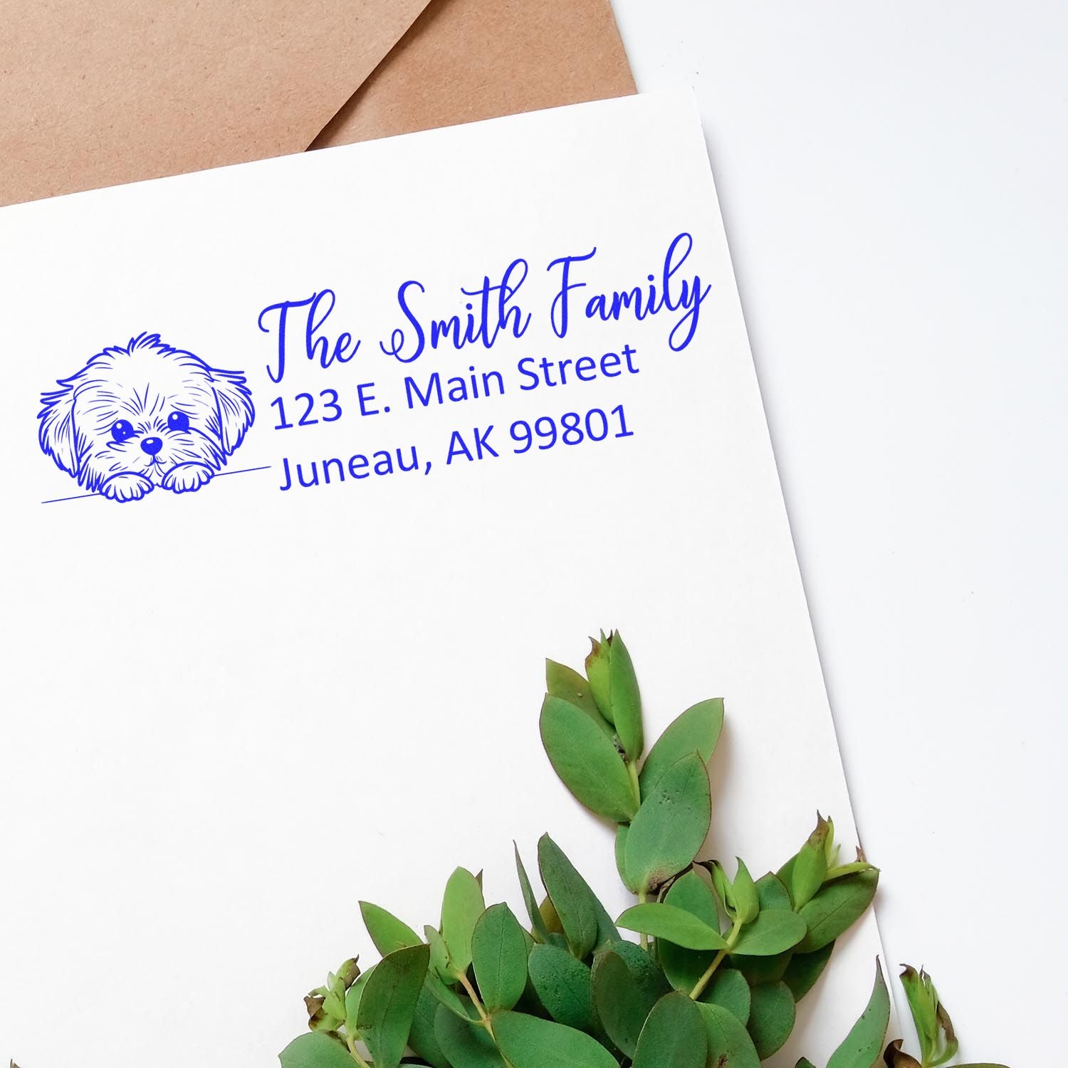 Custom address rubber stamp with dog design for The Smith Family return address, 123 E. Main Street, Juneau, AK 99801.
