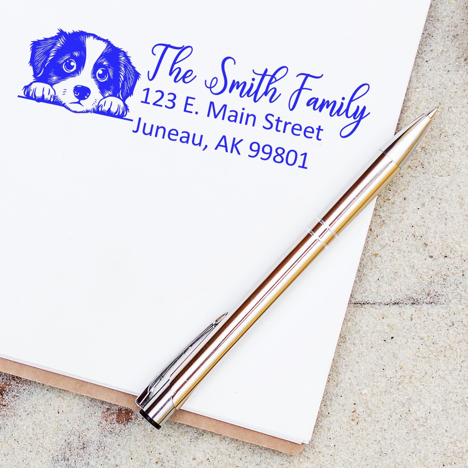 Custom dog address rubber stamp for The Smith Family with puppy illustration and Juneau, AK return address.