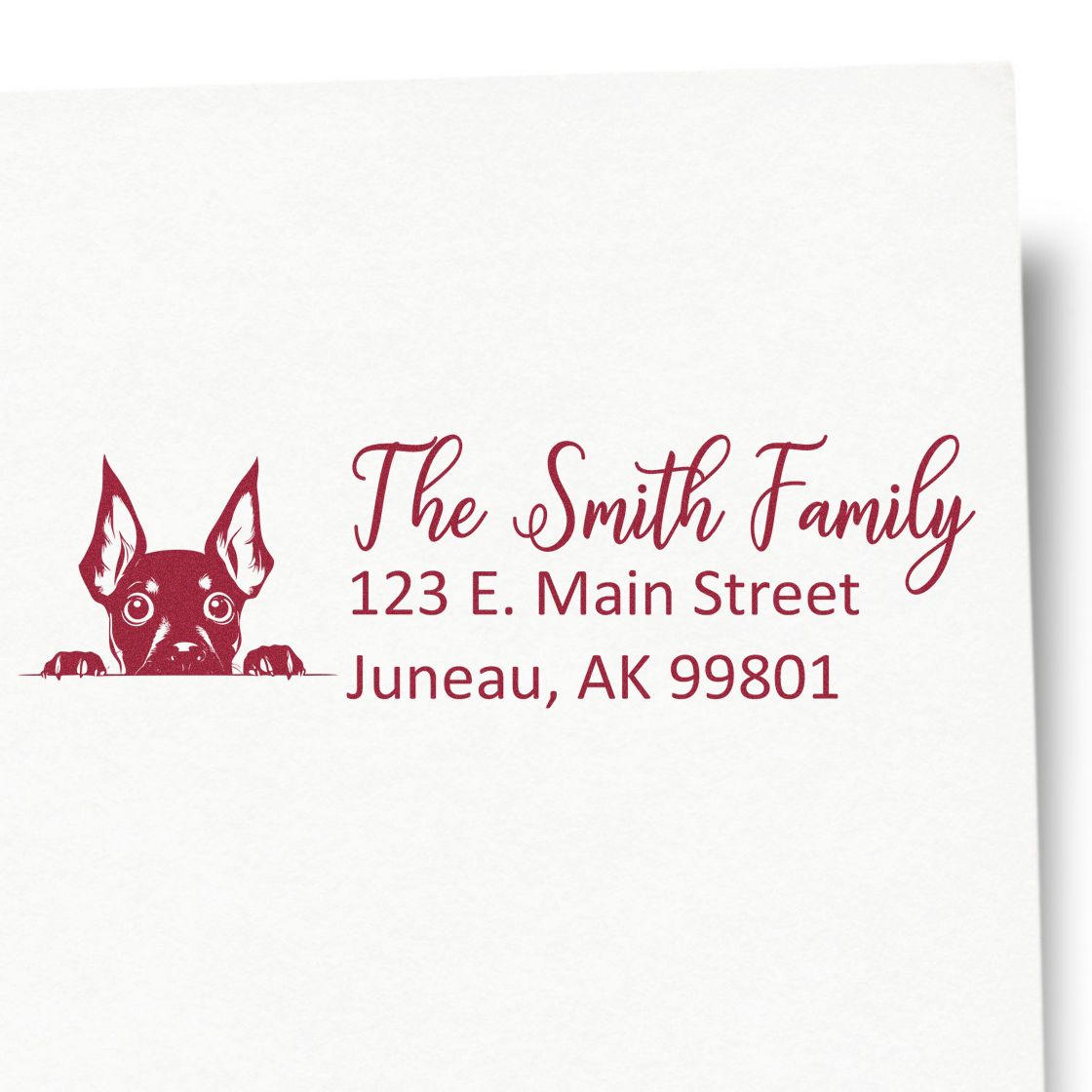 Custom return address rubber stamp with dog logo, The Smith Family name, and Juneau, AK mailing address.
