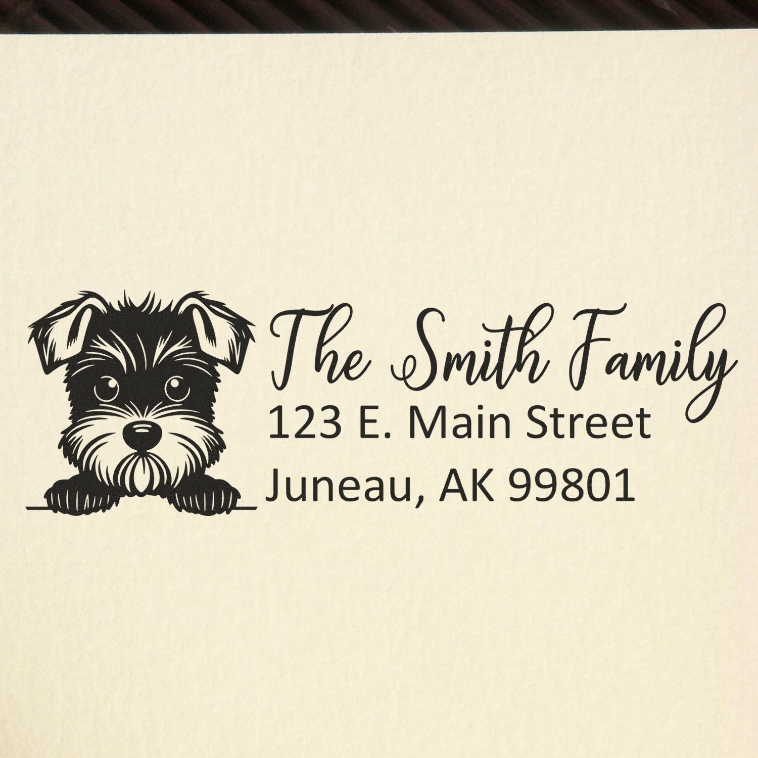 Custom rubber stamp return address with dog illustration: The Smith Family, 123 E. Main Street, Juneau, AK 99801.