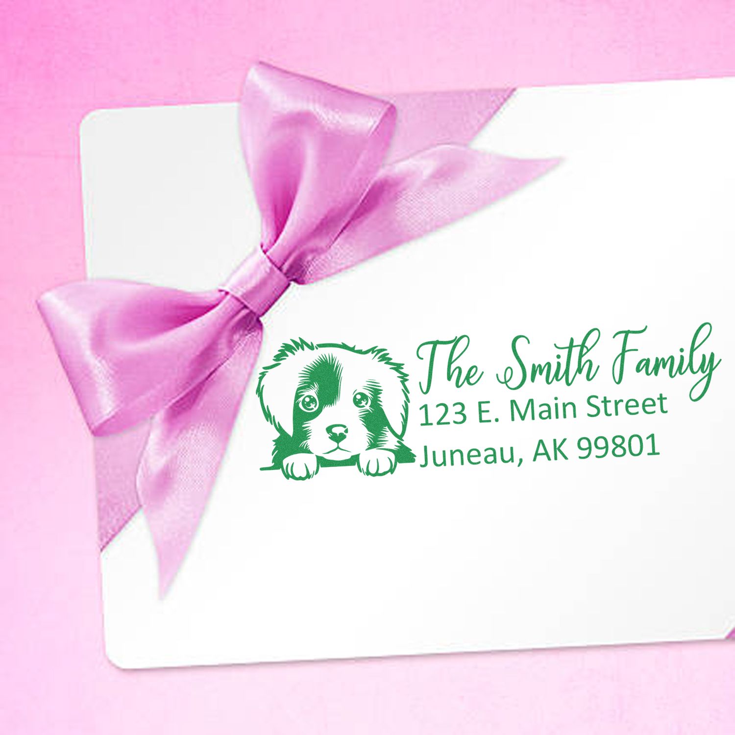 Custom dog address rubber stamp on a gift card with pink ribbon, featuring The Smith Family name and Juneau, AK address.