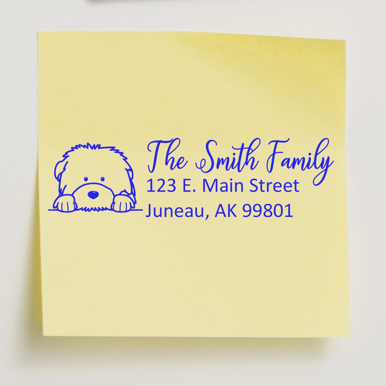 Personalized return address rubber stamp with dog illustration for The Smith Family, 123 E. Main St, Juneau, AK 99801.