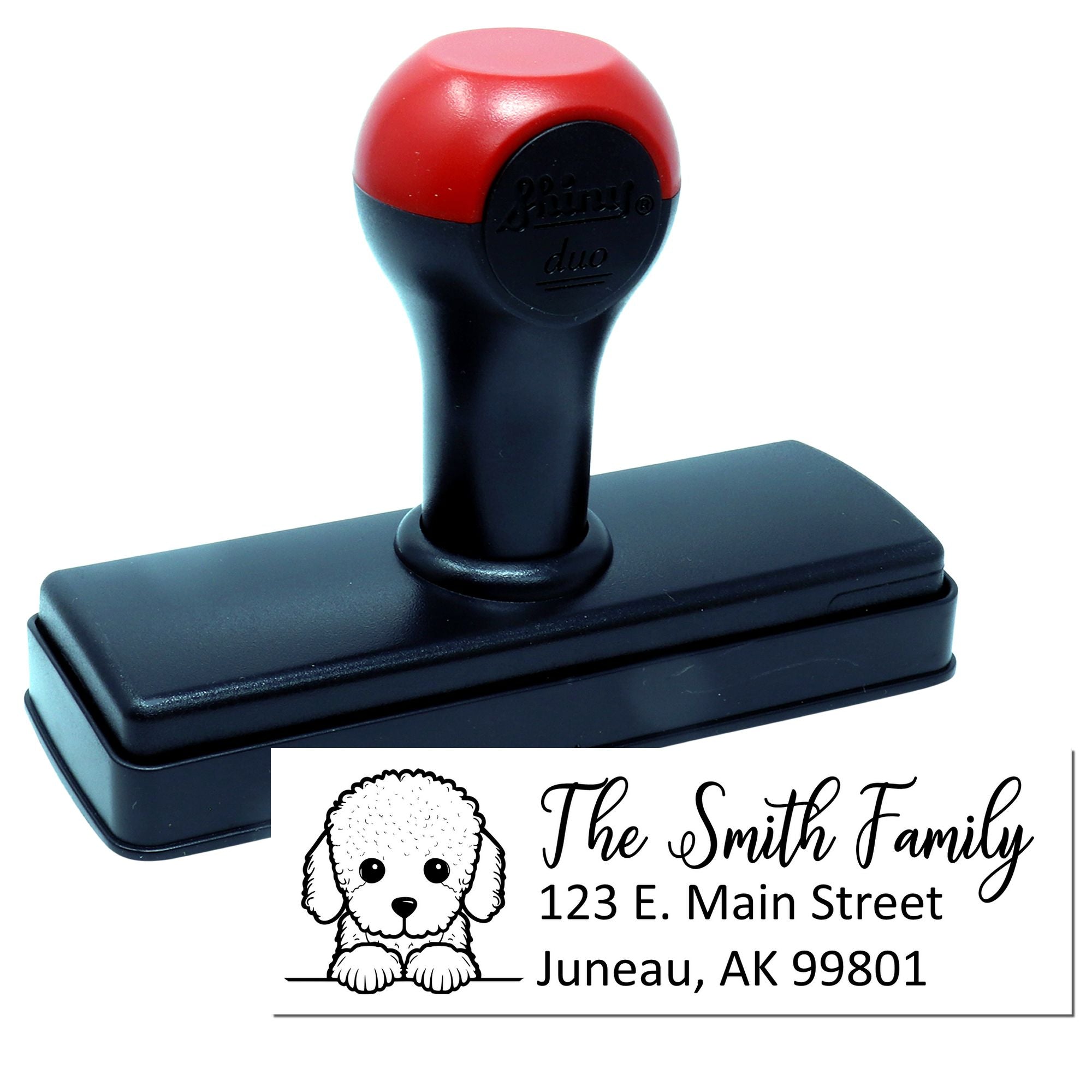 Self-inking custom return address rubber stamp with dog design for The Smith Family, Juneau, AK 99801.