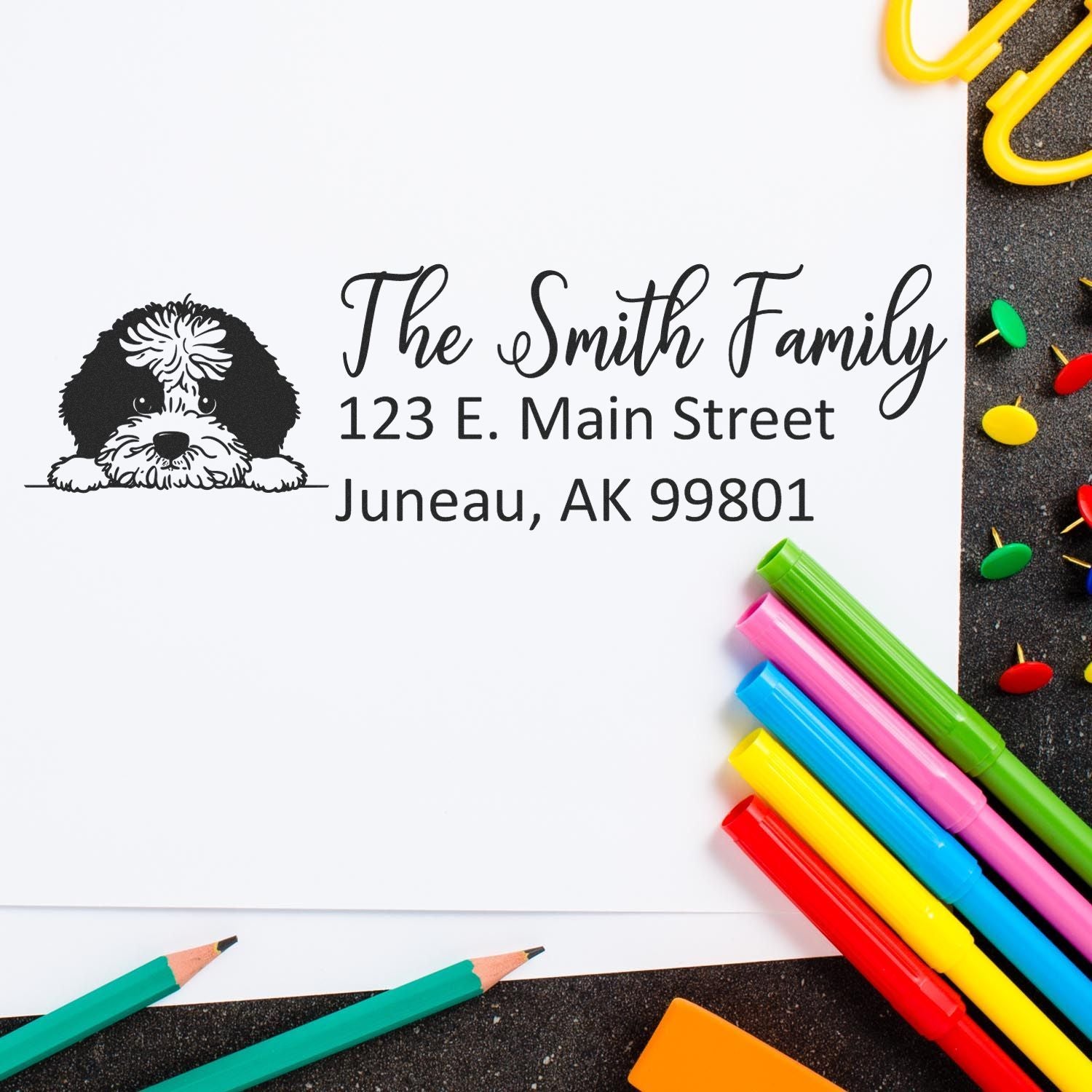 Custom return address rubber stamp with dog illustration, The Smith Family, and Juneau, AK address on stationery.