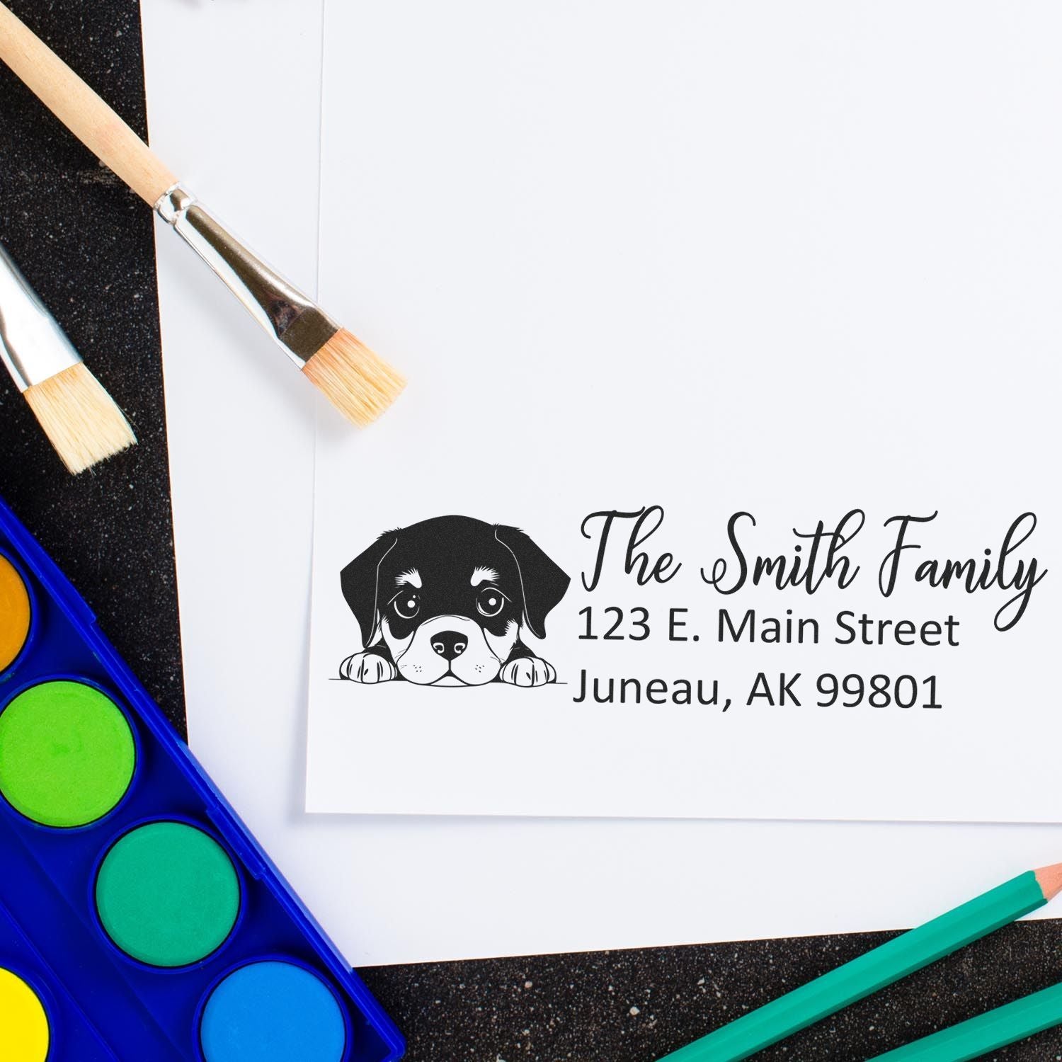 Personalized dog return address rubber stamp with puppy design and family address for custom mailing labels.