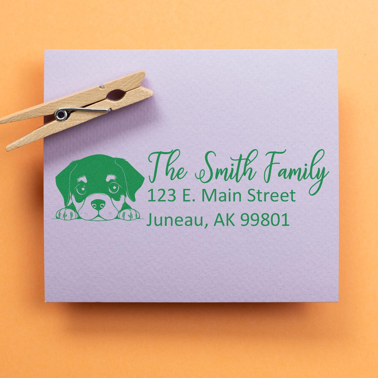 Custom return address rubber stamp with puppy design for The Smith Family, featuring Juneau, AK mailing address.