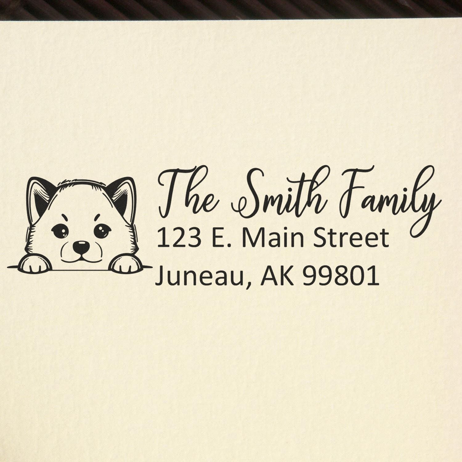 Custom rubber address stamp with dog design for The Smith Family, Juneau, AK return address.