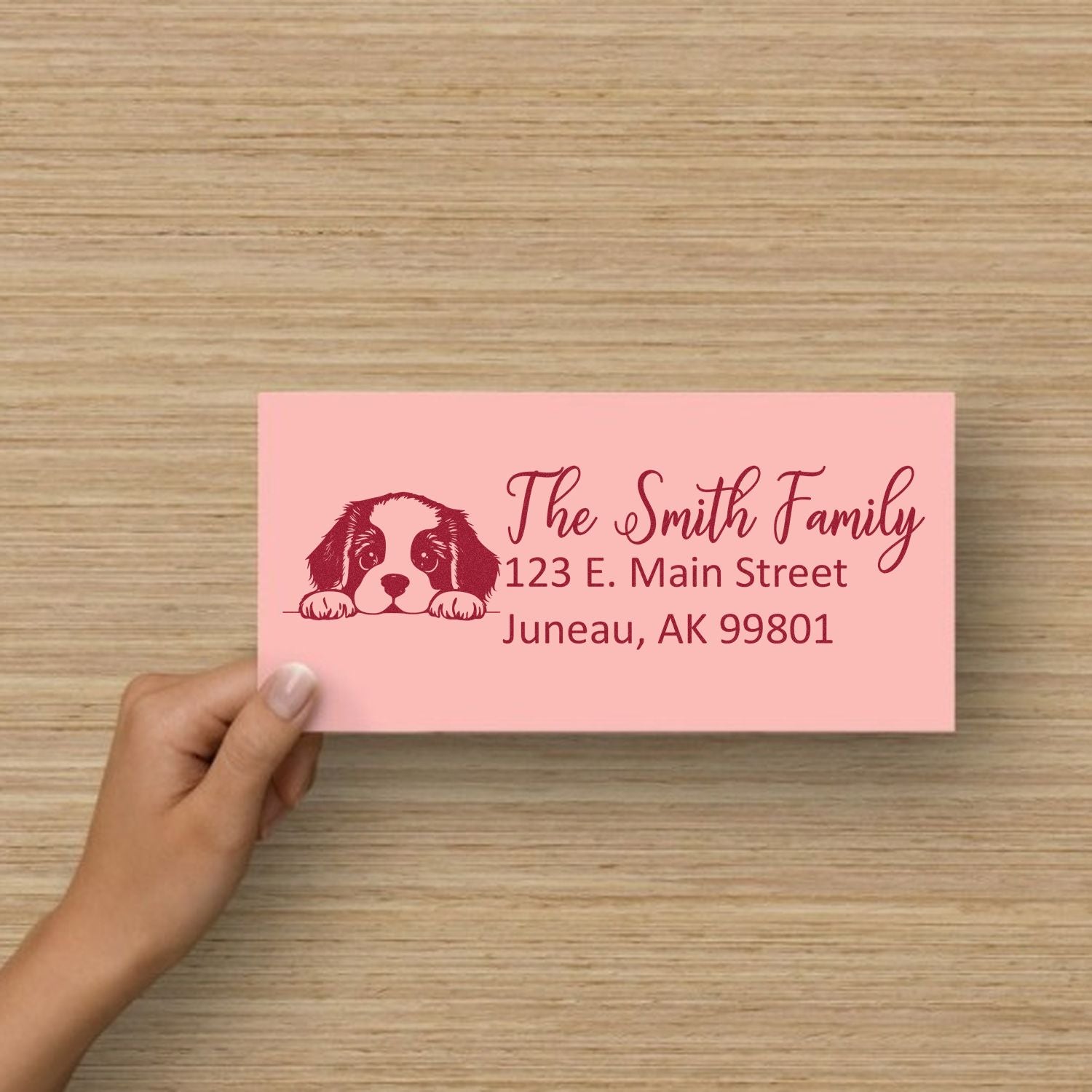 Custom dog return address rubber stamp with puppy illustration and The Smith Family address on a pink card.