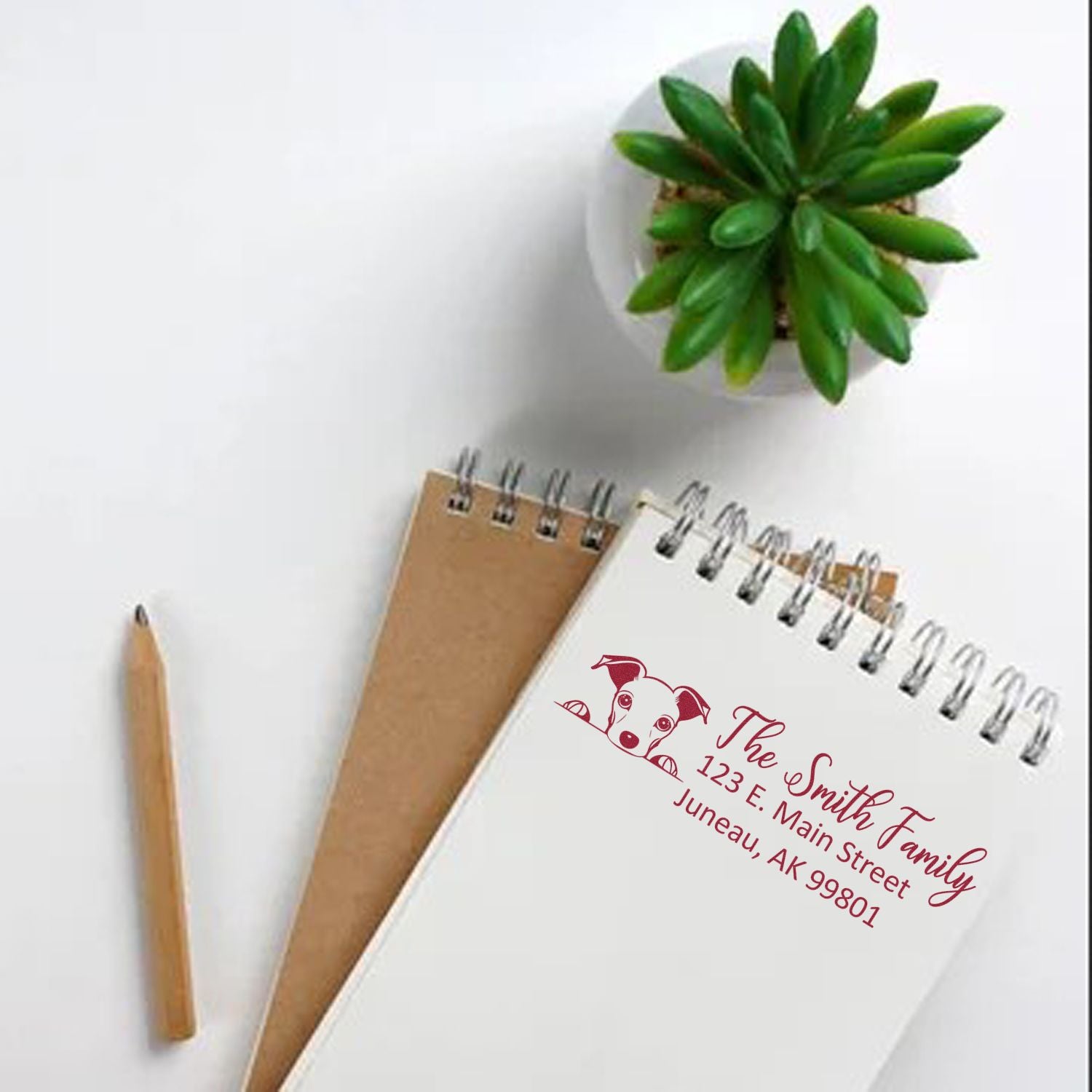 Personalized return address rubber stamp with dog logo, used on stationery and envelopes for family mailings.